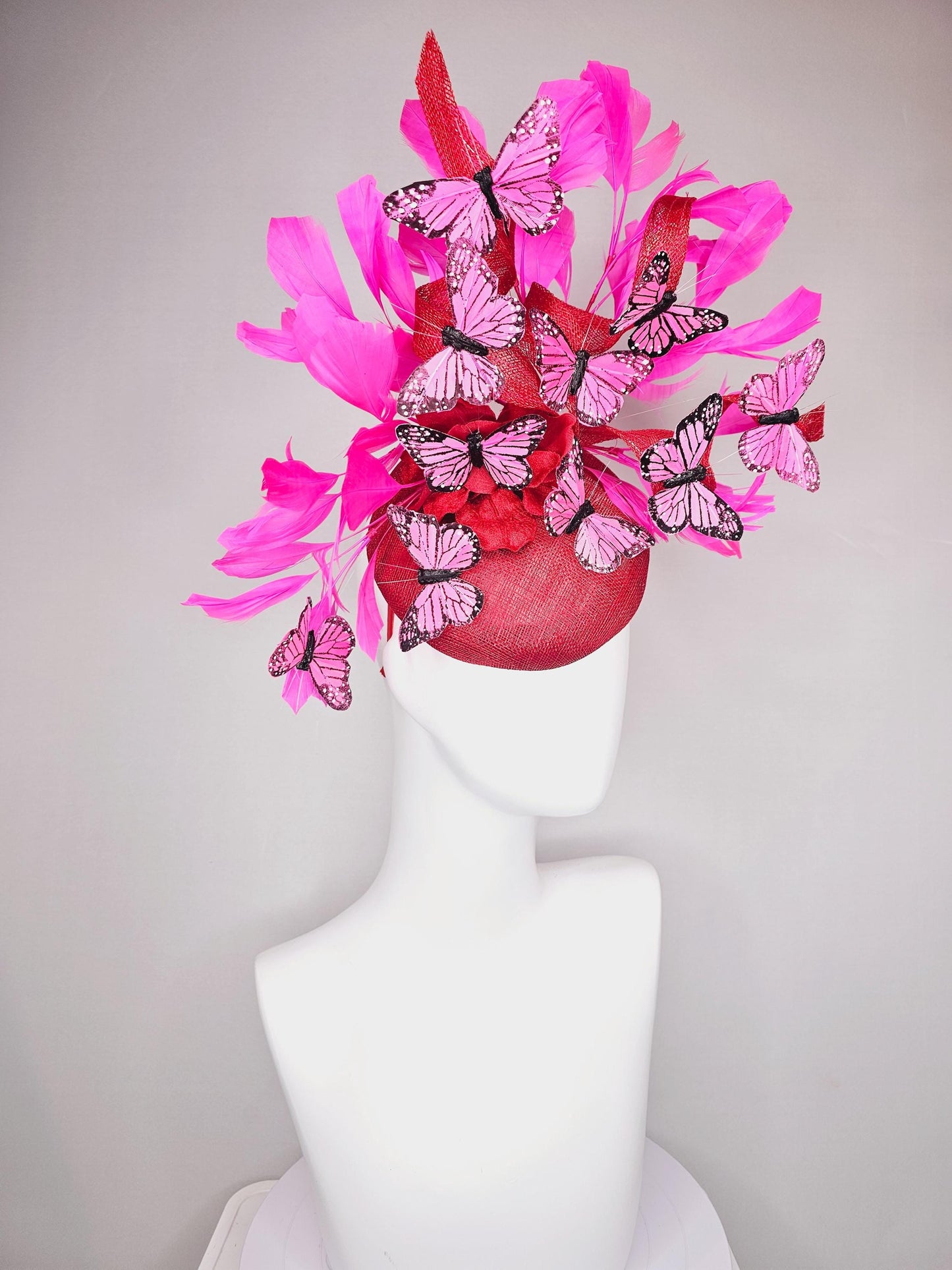 kentucky derby hat fascinator cherry red sinamay with curls hot pink fuchsia branching feathers and pink and black butterflies