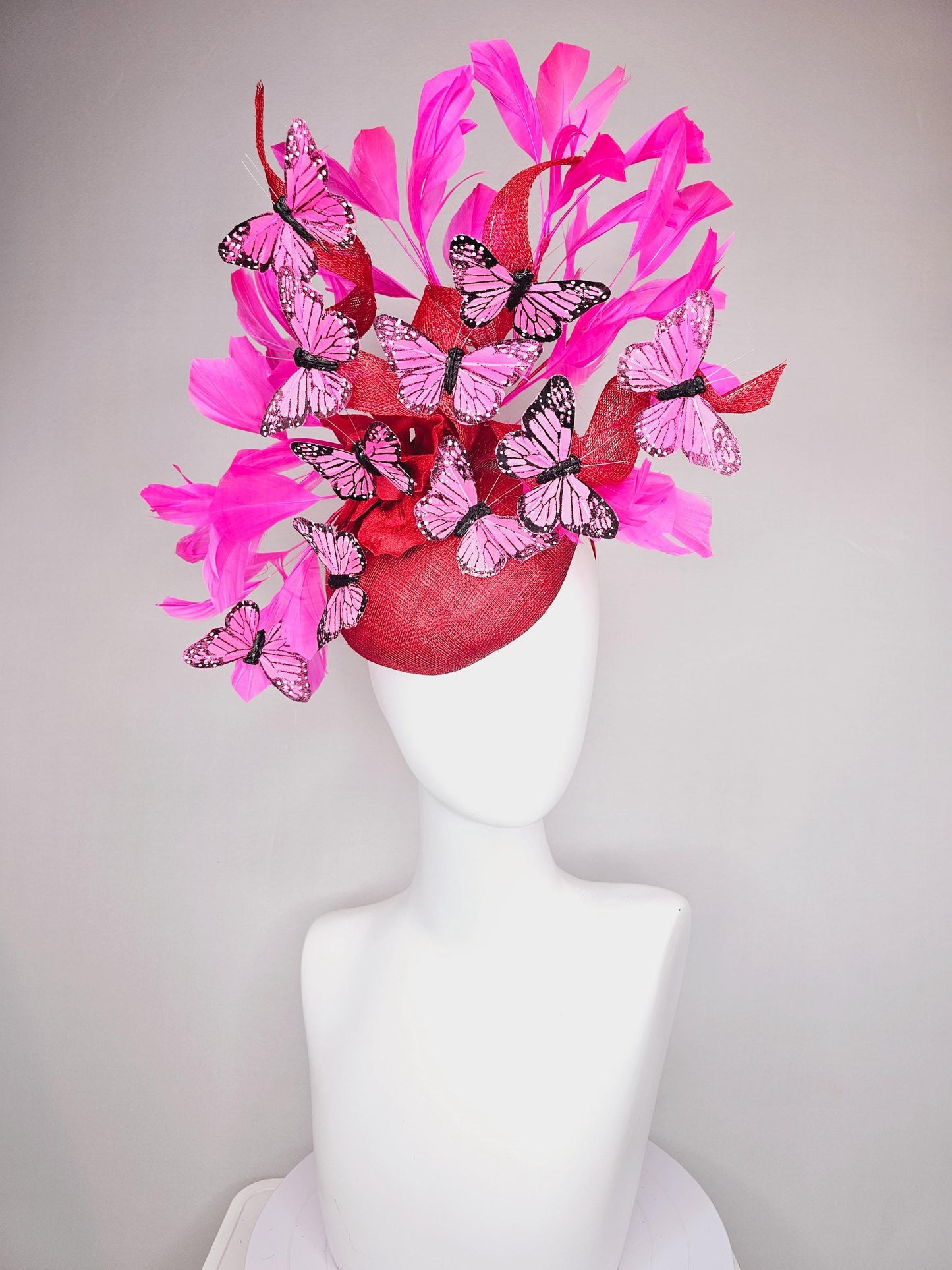 kentucky derby hat fascinator cherry red sinamay with curls hot pink fuchsia branching feathers and pink and black butterflies