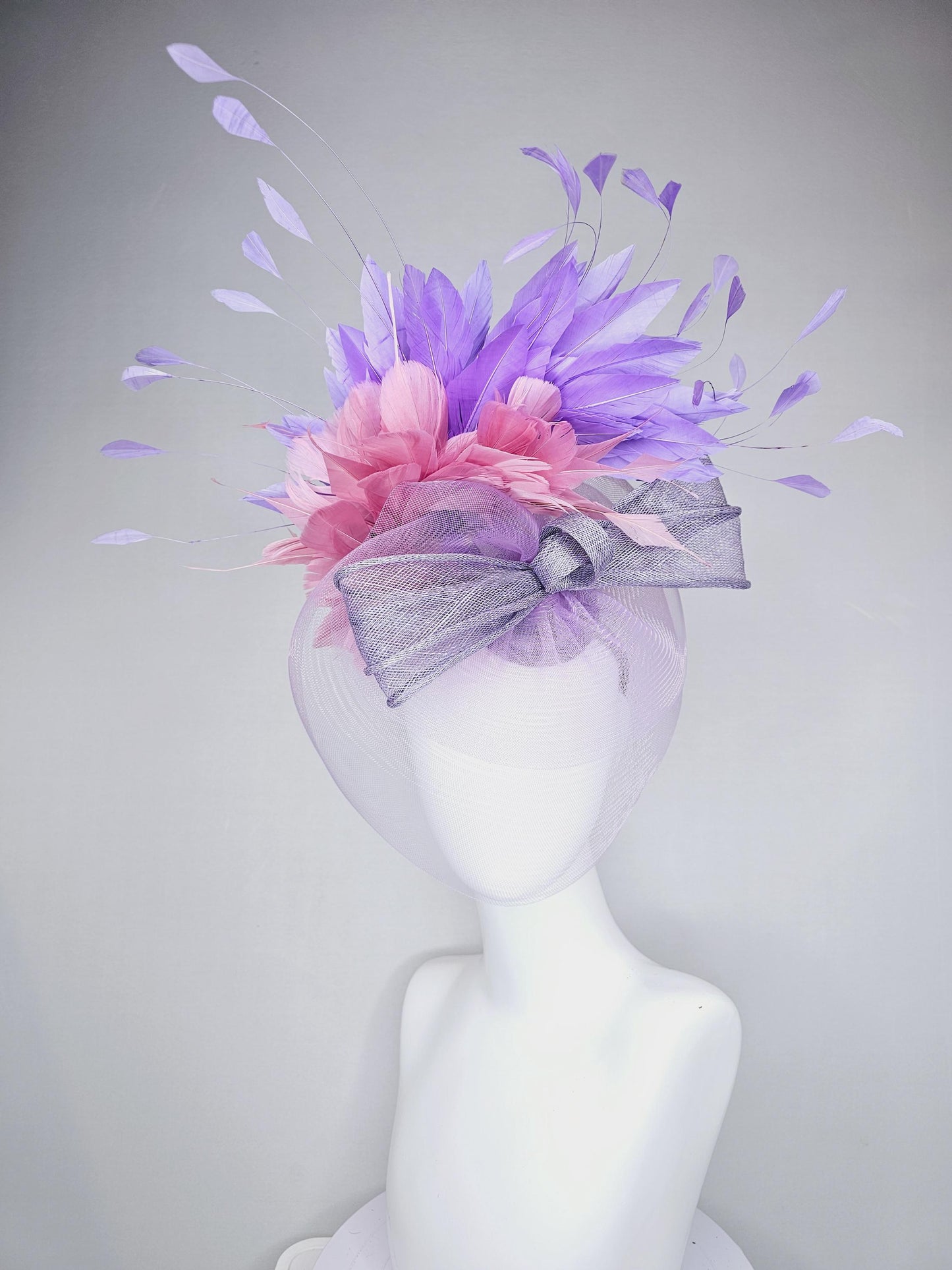 kentucky derby hat fascinator large purple sinamay bow with lavender and light pink branching feathers with purple mesh veil on a headband