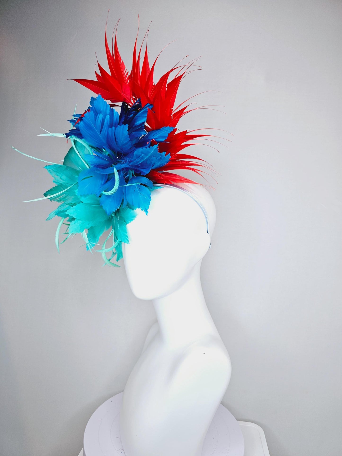 kentucky derby hat fascinator with fluffy aqua blue mint green cobalt blue zigzag feather flowers and red branching feathers