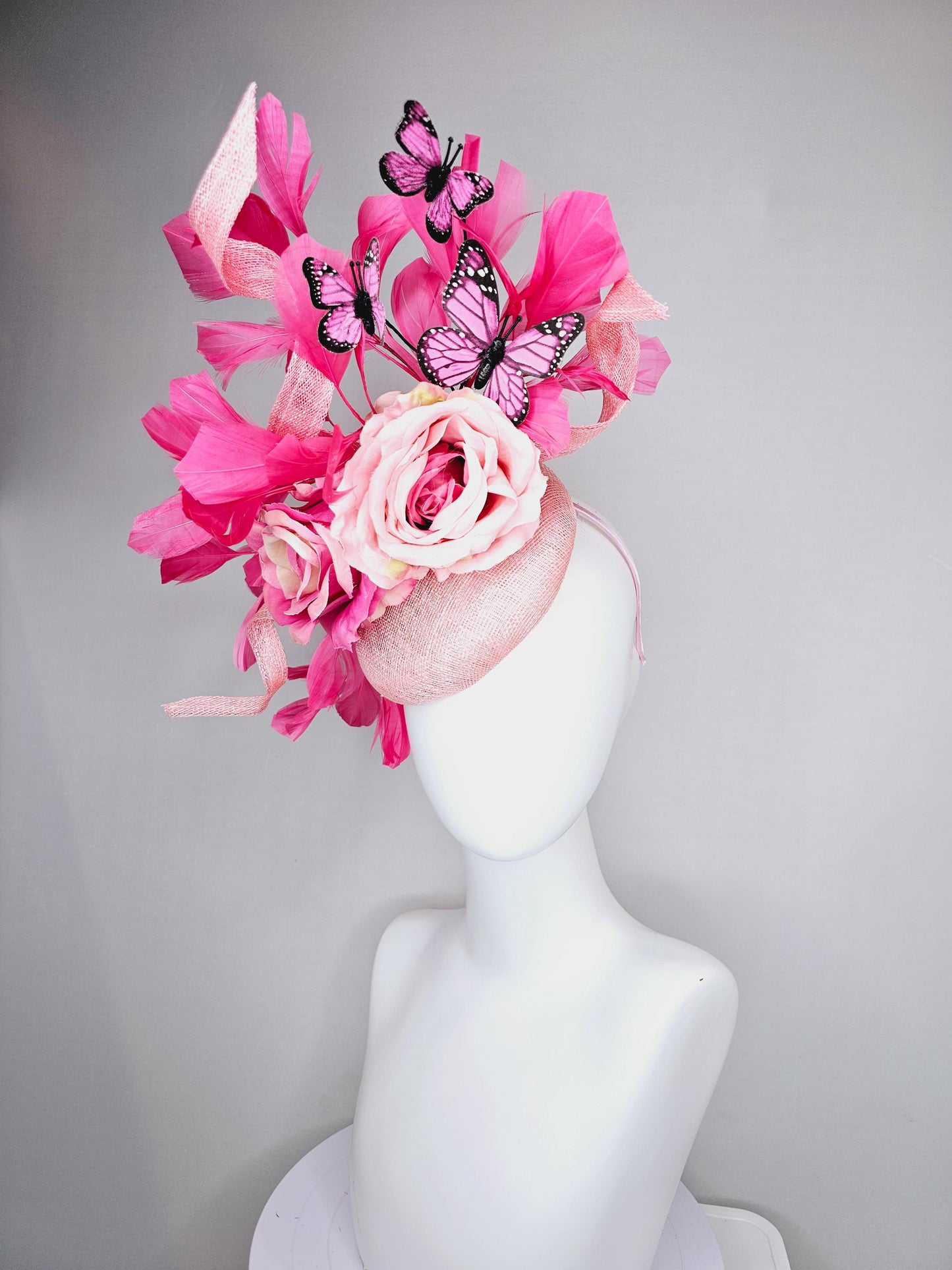 kentucky derby hat fascinator blush pink sinamay with sinamay curls, pink blush pink satin roses, pink feathers, pink and black butterflies