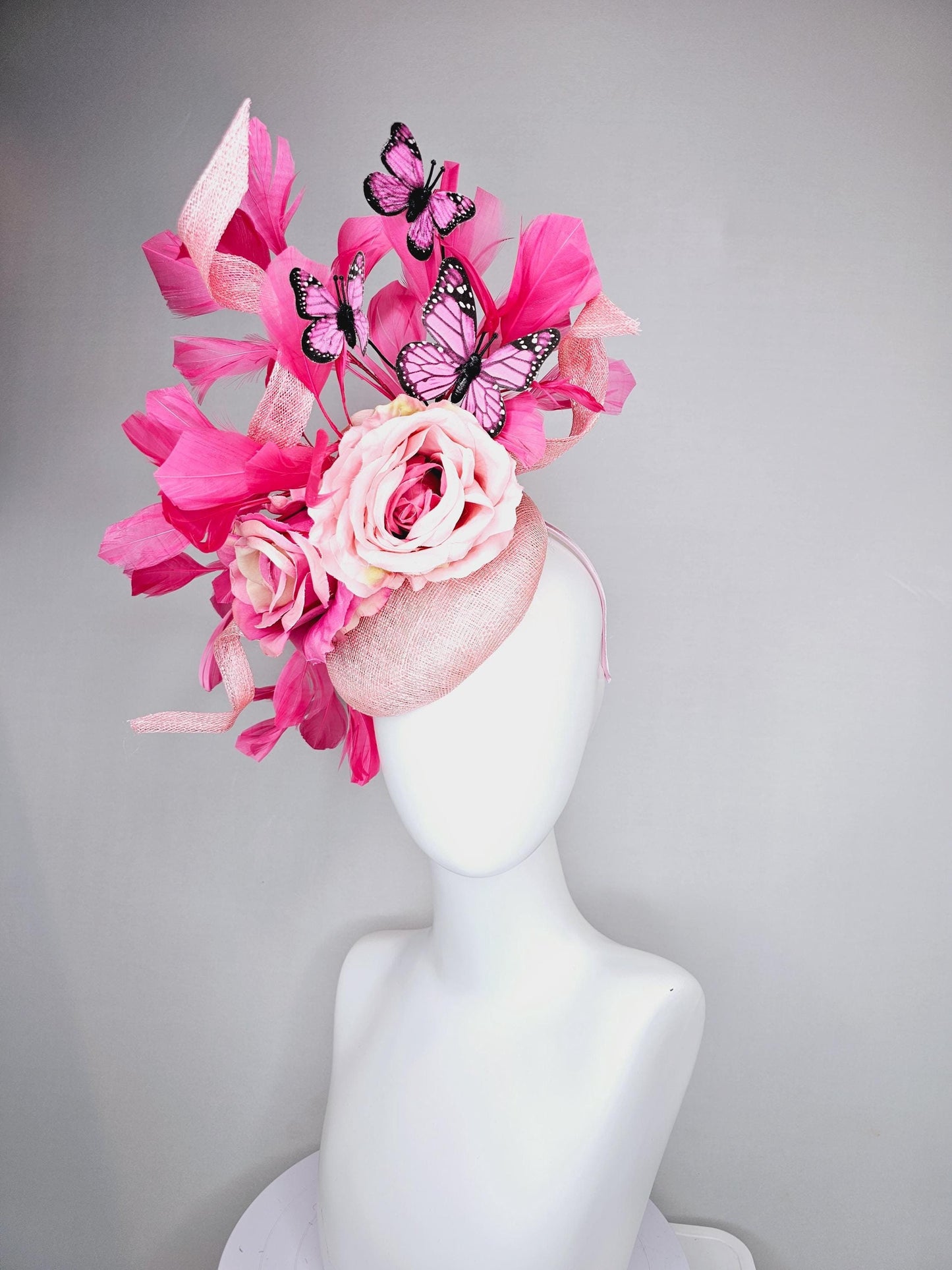 kentucky derby hat fascinator blush pink sinamay with sinamay curls, pink blush pink satin roses, pink feathers, pink and black butterflies