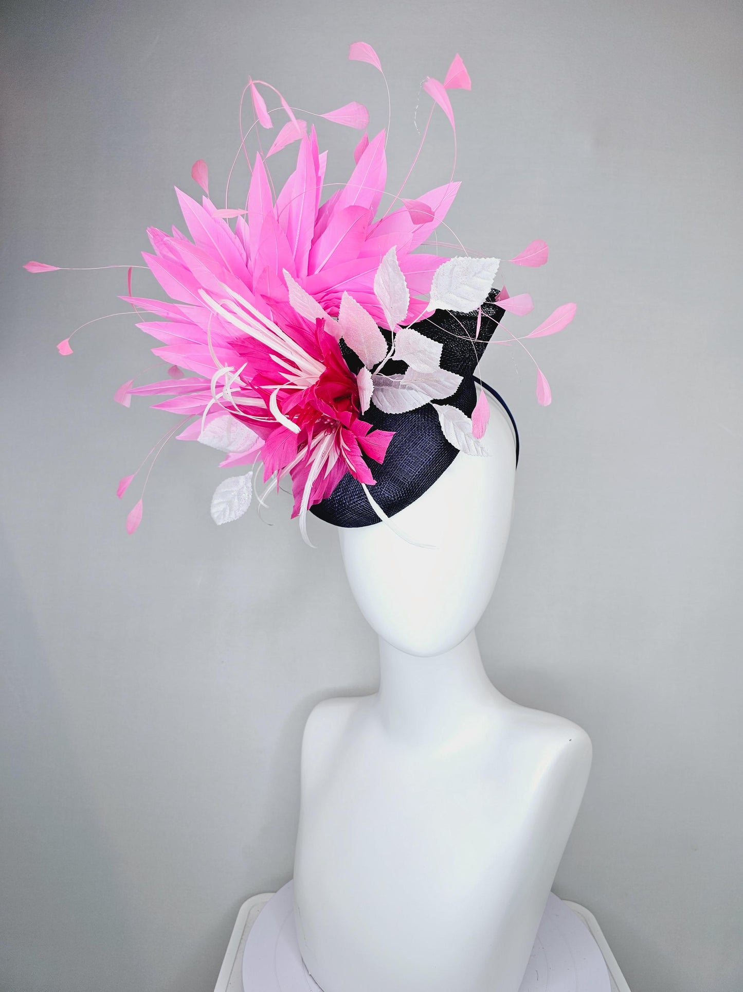 kentucky derby hat fascinator navy blue sinamay with hot pink feather flower, white velvet leaves and blush pink branching feathers