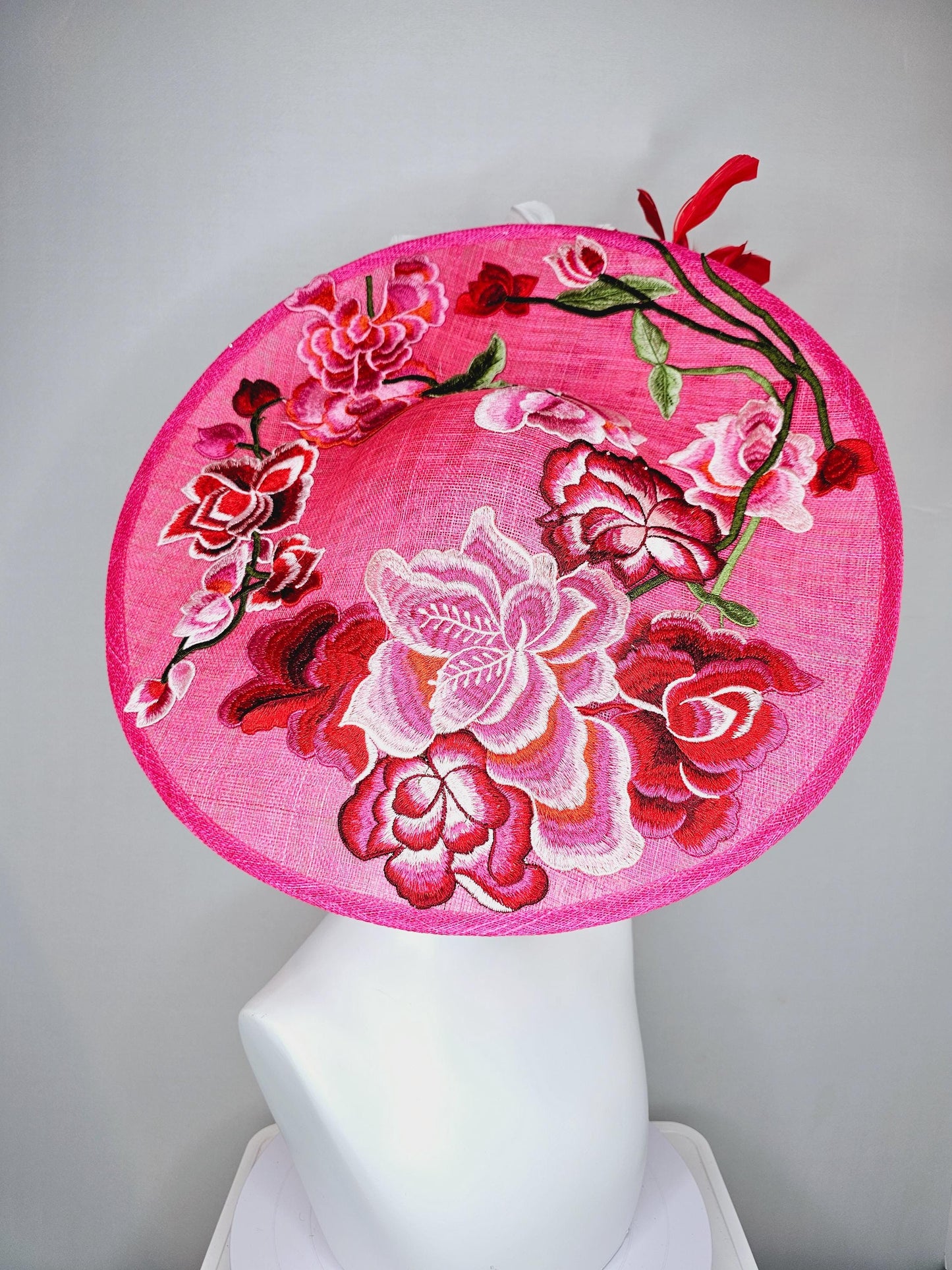 kentucky derby hat fascinator hot pink large saucer with red,pink,white embroidered flowers,green leaves,red and white branching feathers