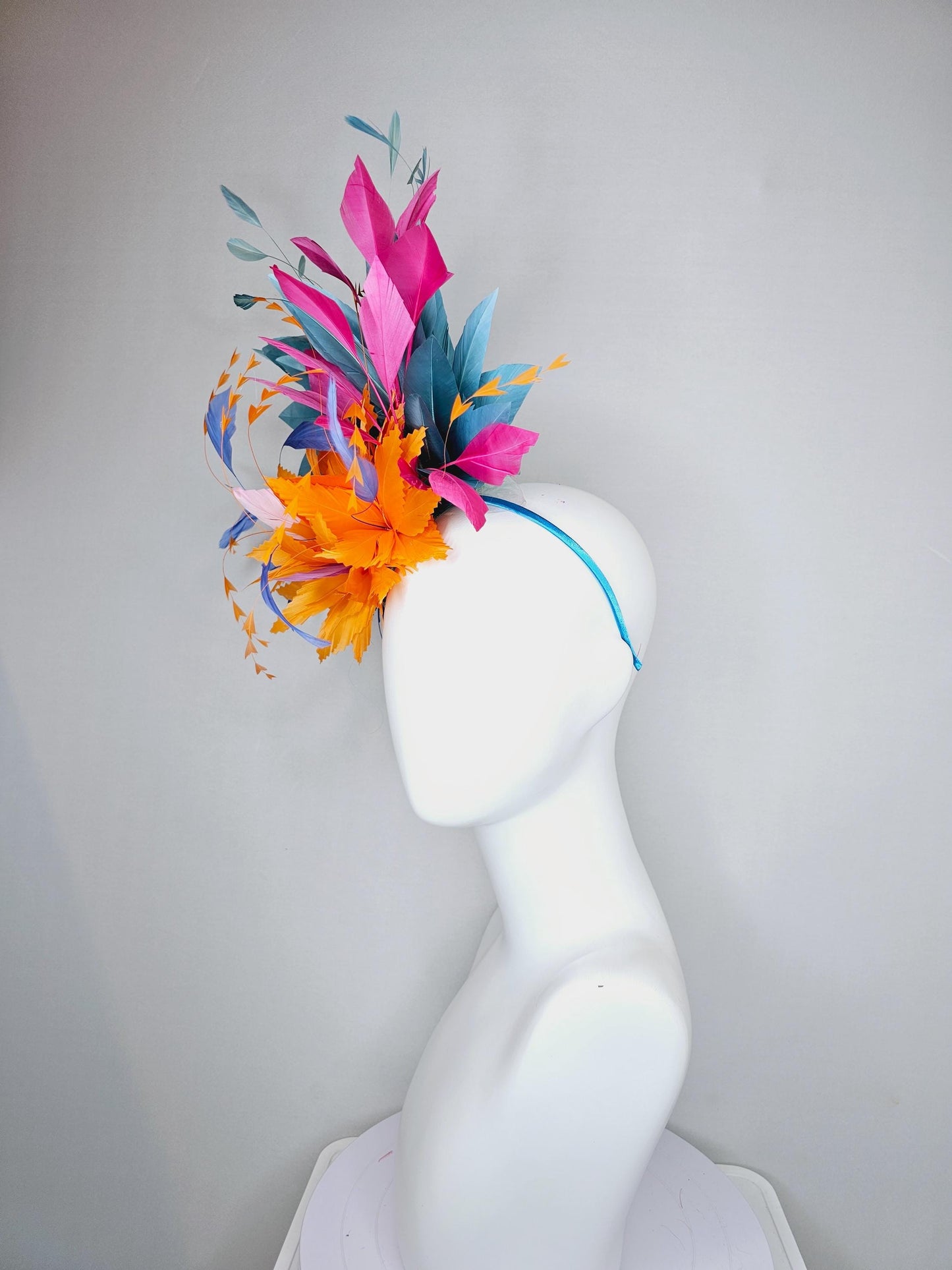 kentucky derby hat fascinator tangerine orange feather flower with colorful pink,blue teal,and cobalt blue branching feathers