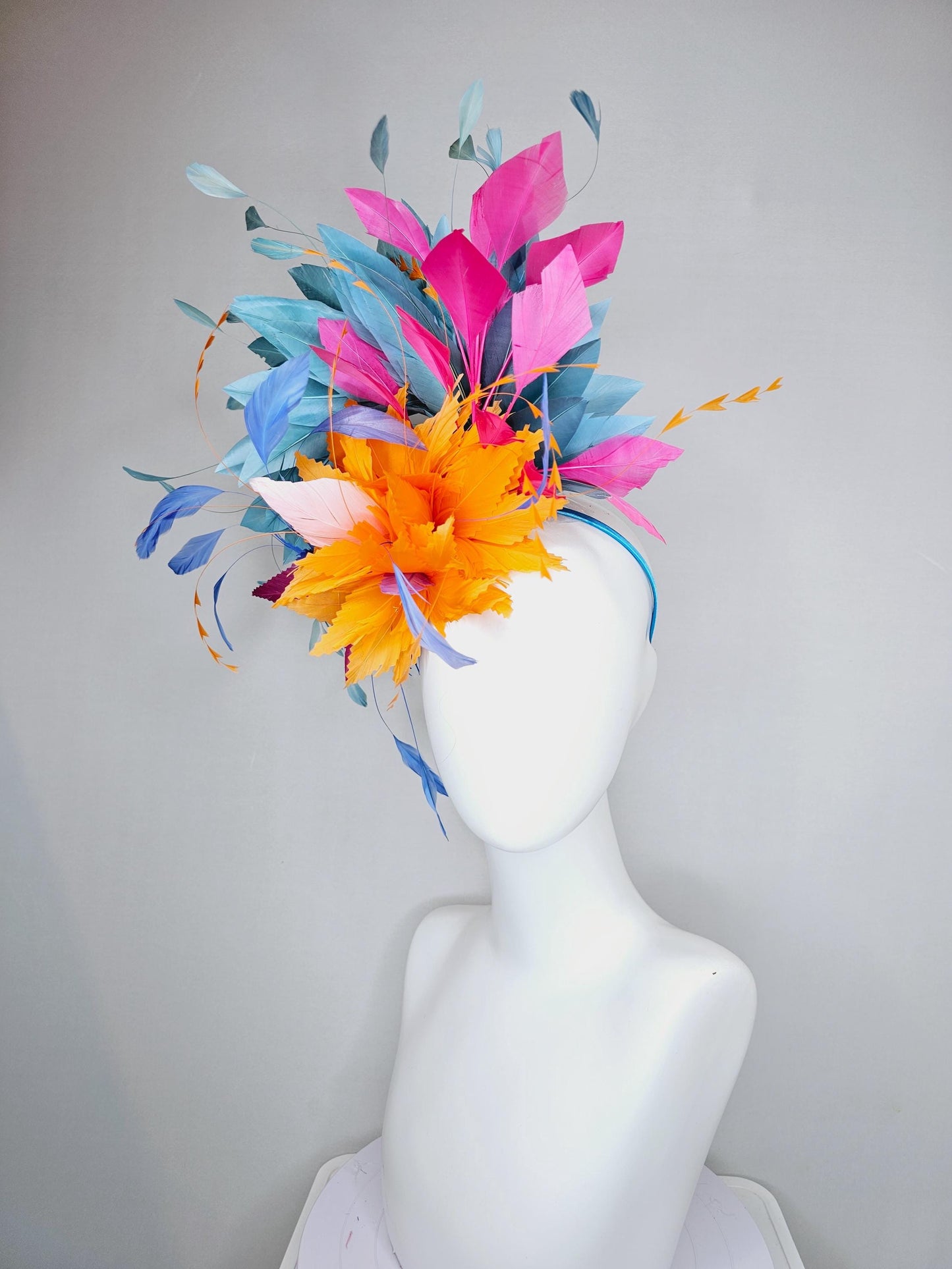 kentucky derby hat fascinator tangerine orange feather flower with colorful pink,blue teal,and cobalt blue branching feathers