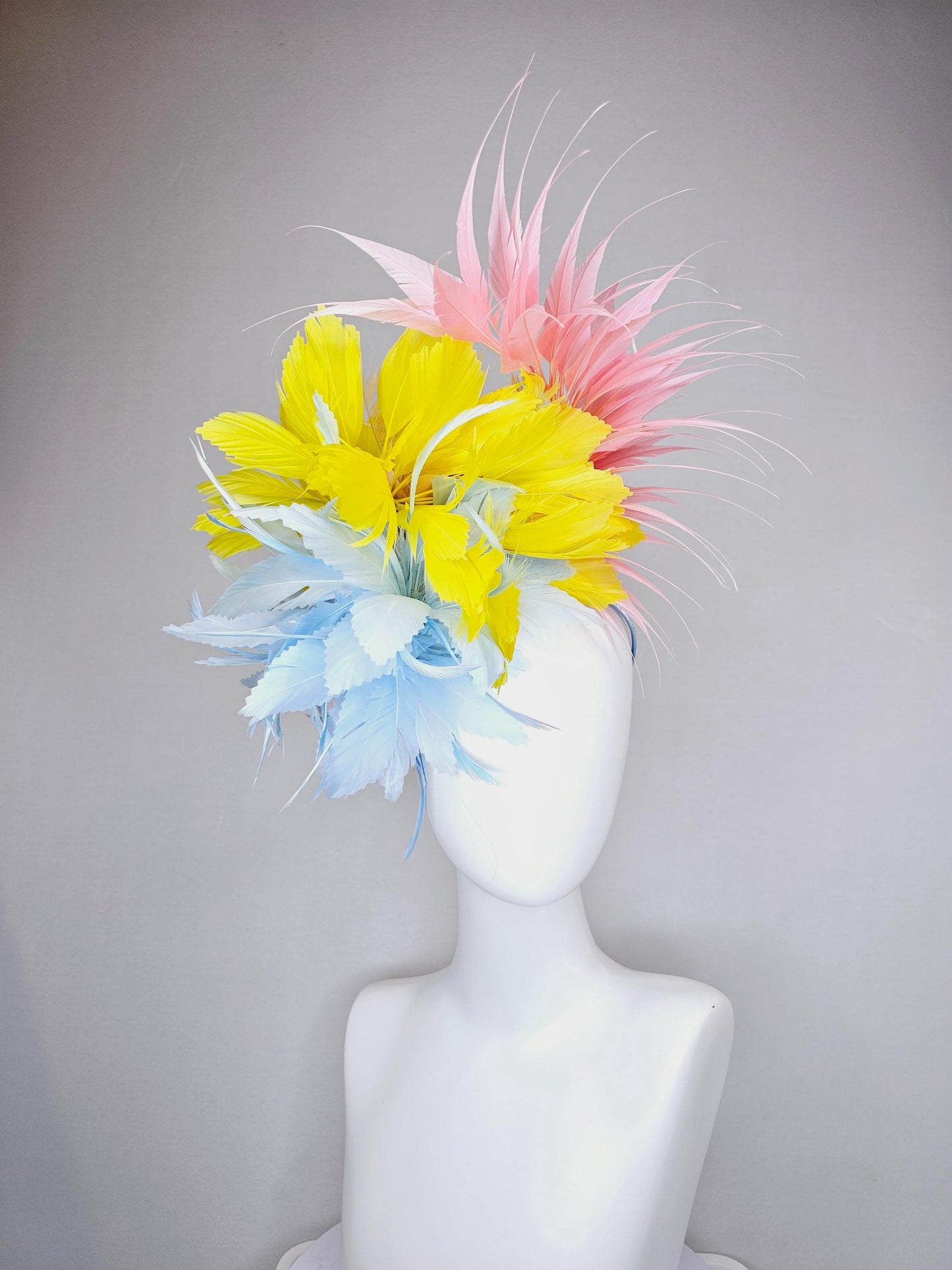 kentucky derby hat fascinator light blue fluffy zigzag feather flower with bright yellow branching feathers and light pink pointy feathers