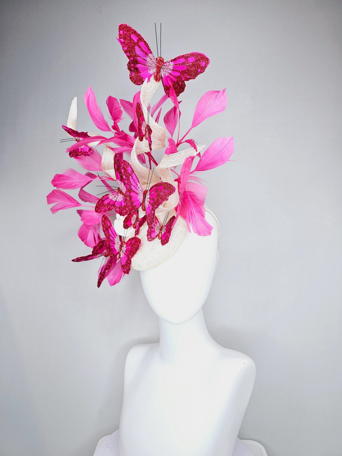 kentucky derby hat fascinator white sinamay with tall curls,pink branching feathers,pink fuchsia glitter sparkle large butterflies