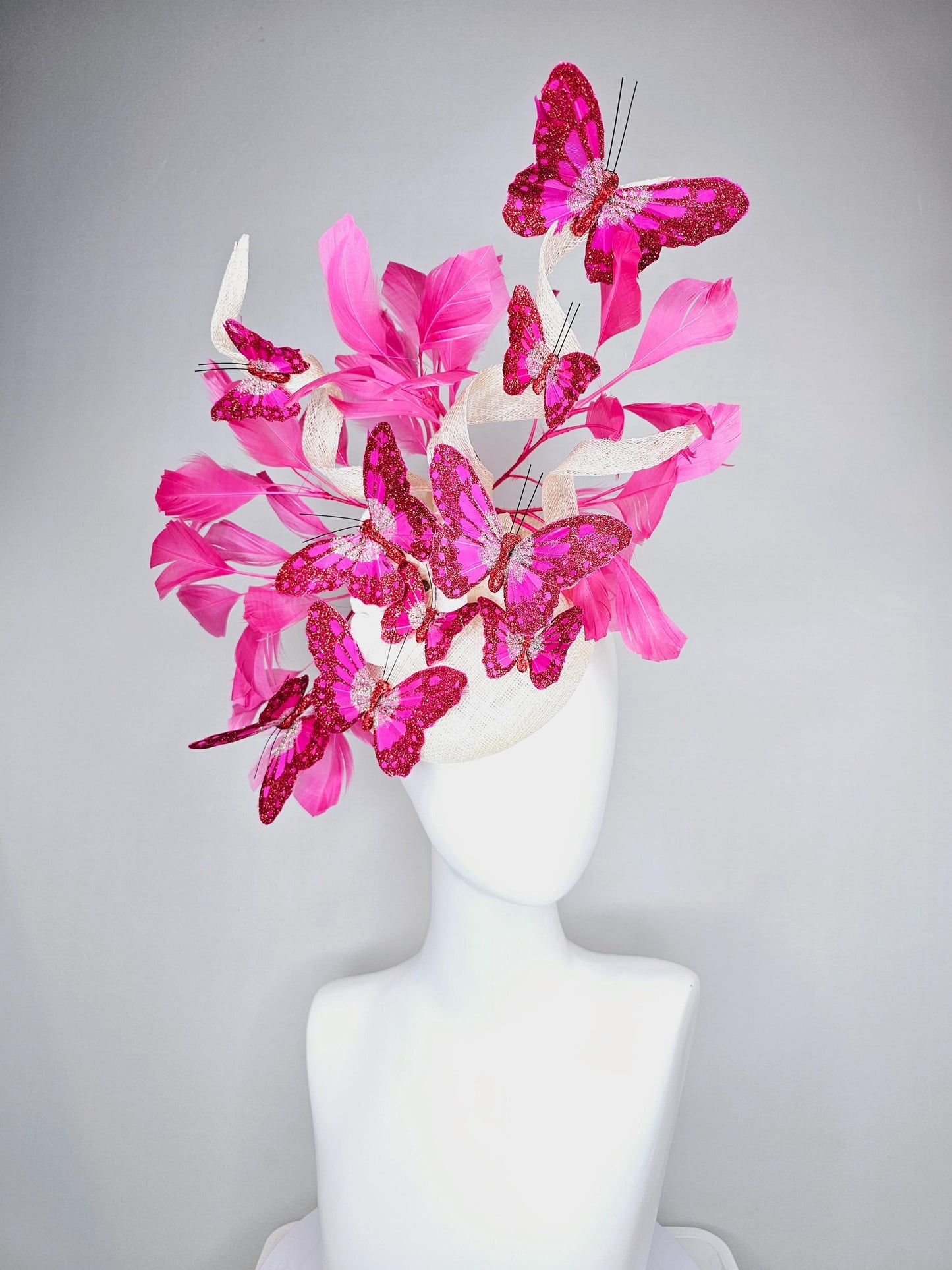 kentucky derby hat fascinator white sinamay with tall curls,pink branching feathers,pink fuchsia glitter sparkle large butterflies