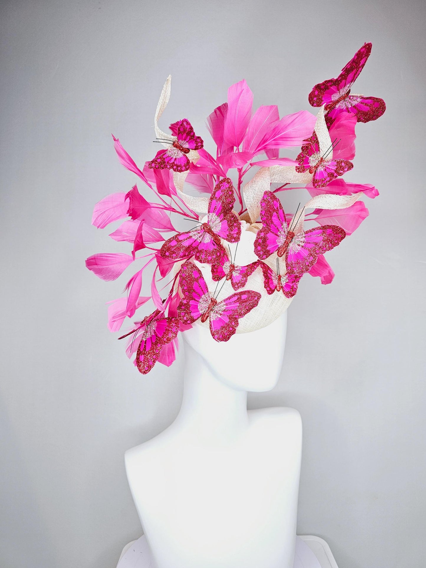 kentucky derby hat fascinator white sinamay with tall curls,pink branching feathers,pink fuchsia glitter sparkle large butterflies