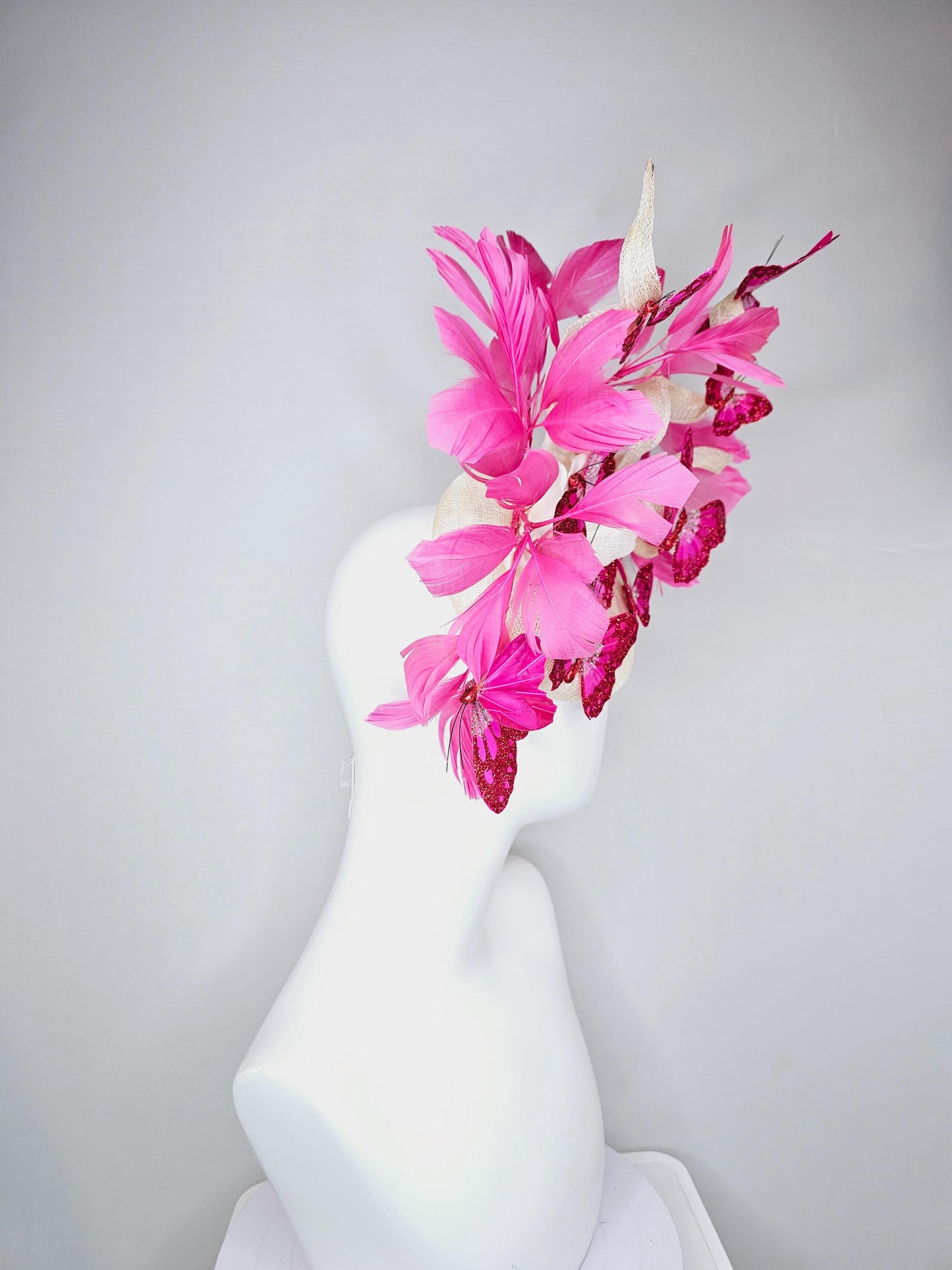 kentucky derby hat fascinator white sinamay with tall curls,pink branching feathers,pink fuchsia glitter sparkle large butterflies