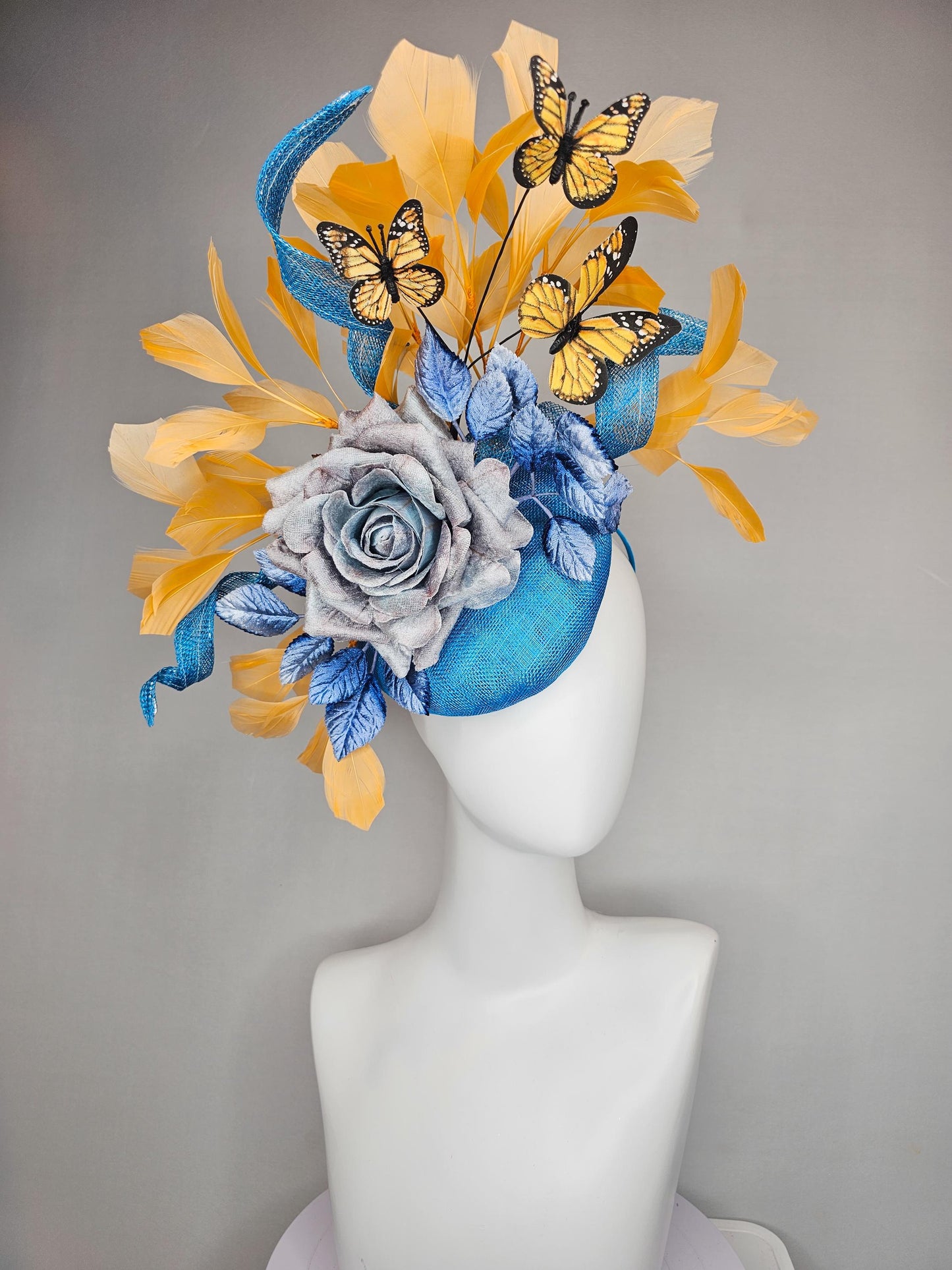 kentucky derby hat fascinator blue sinamay w/ curls,blue purple ombre rose,blue leaves,apricot orange yellow feathers w/ apricot butterflies