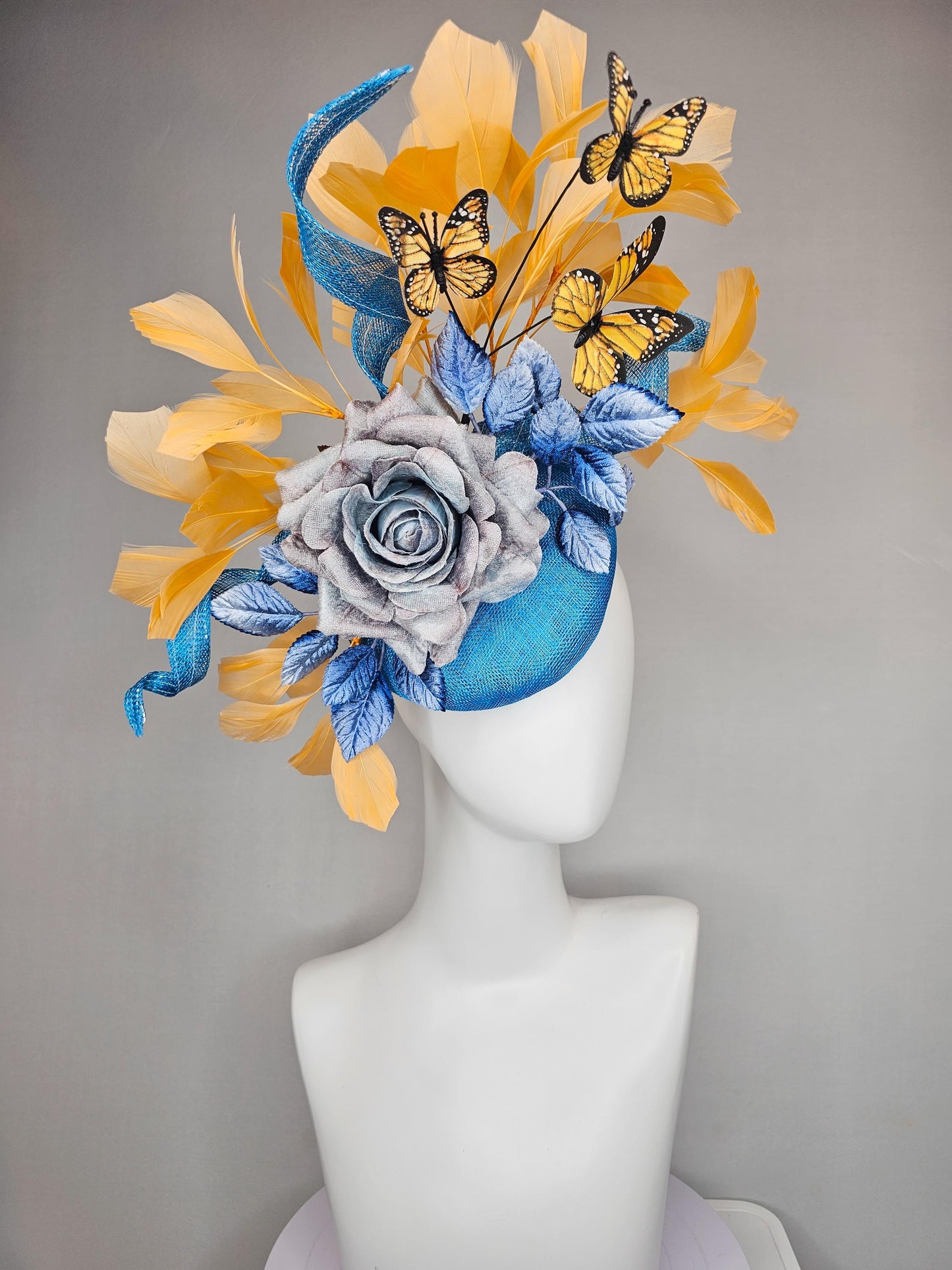 kentucky derby hat fascinator blue sinamay w/ curls,blue purple ombre rose,blue leaves,apricot orange yellow feathers w/ apricot butterflies