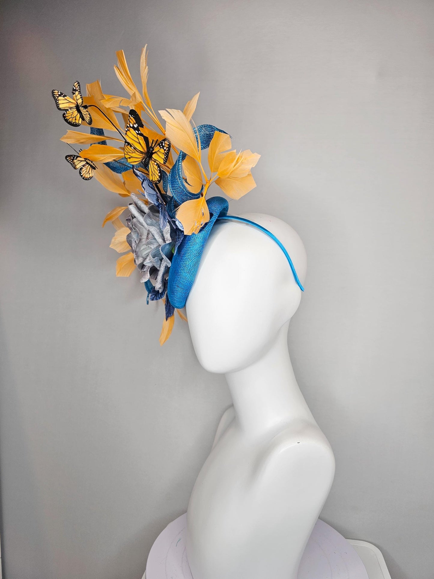 kentucky derby hat fascinator blue sinamay w/ curls,blue purple ombre rose,blue leaves,apricot orange yellow feathers w/ apricot butterflies