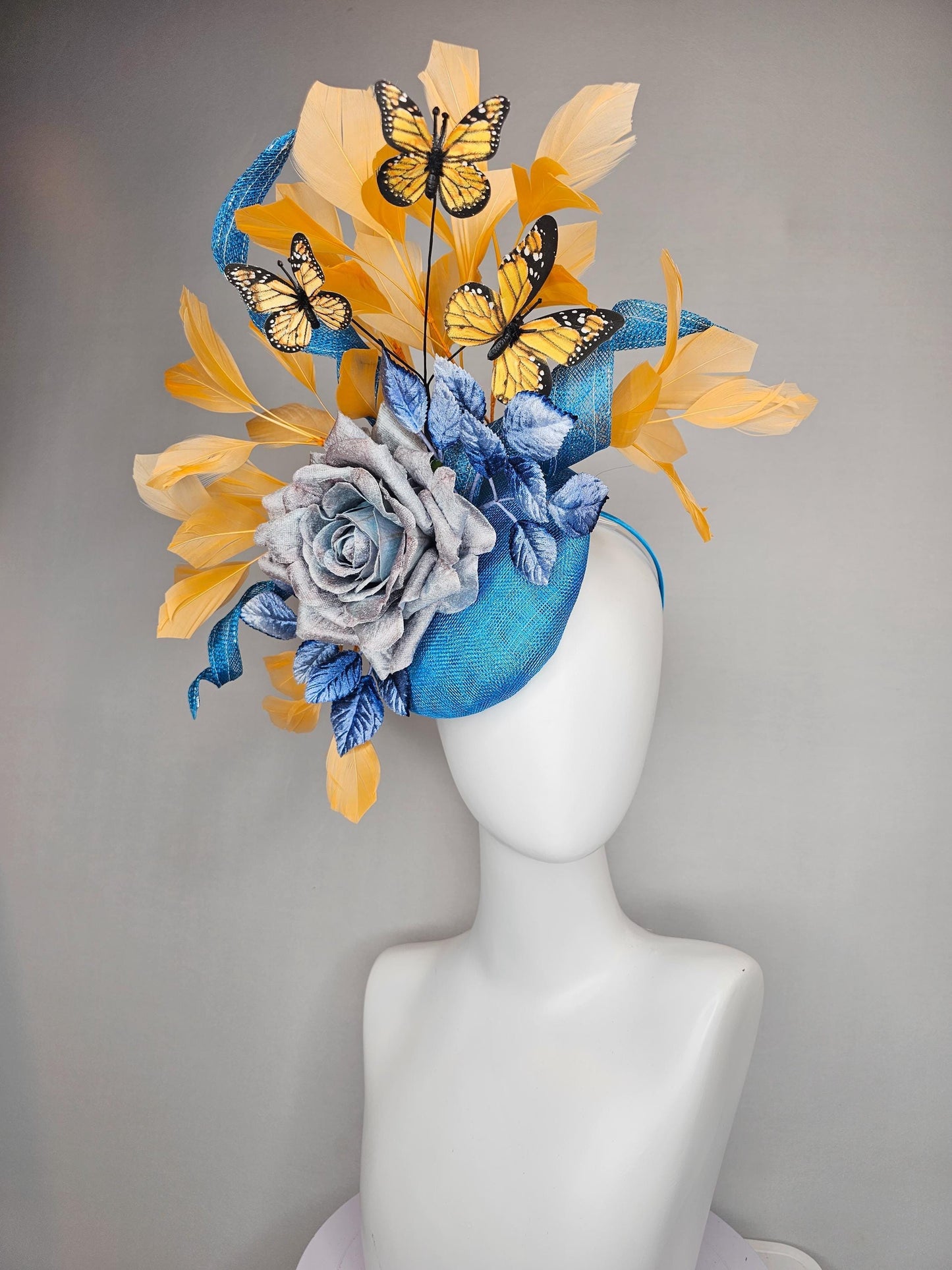 kentucky derby hat fascinator blue sinamay w/ curls,blue purple ombre rose,blue leaves,apricot orange yellow feathers w/ apricot butterflies