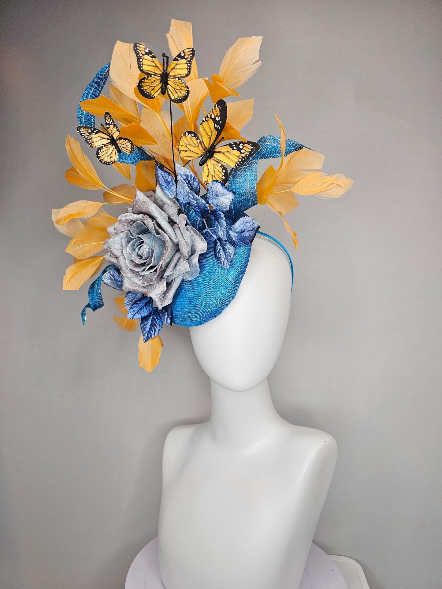 kentucky derby hat fascinator blue sinamay w/ curls,blue purple ombre rose,blue leaves,apricot orange yellow feathers w/ apricot butterflies