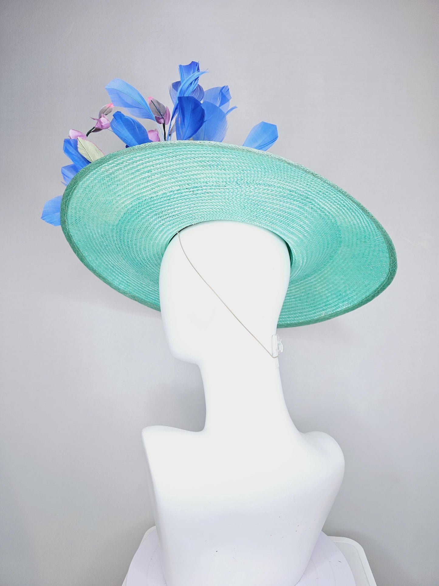 kentucky derby hat wide brim straw in aqua mint green with pink satin rose and lilac lavender purple satin rose stems cobalt blue feathers