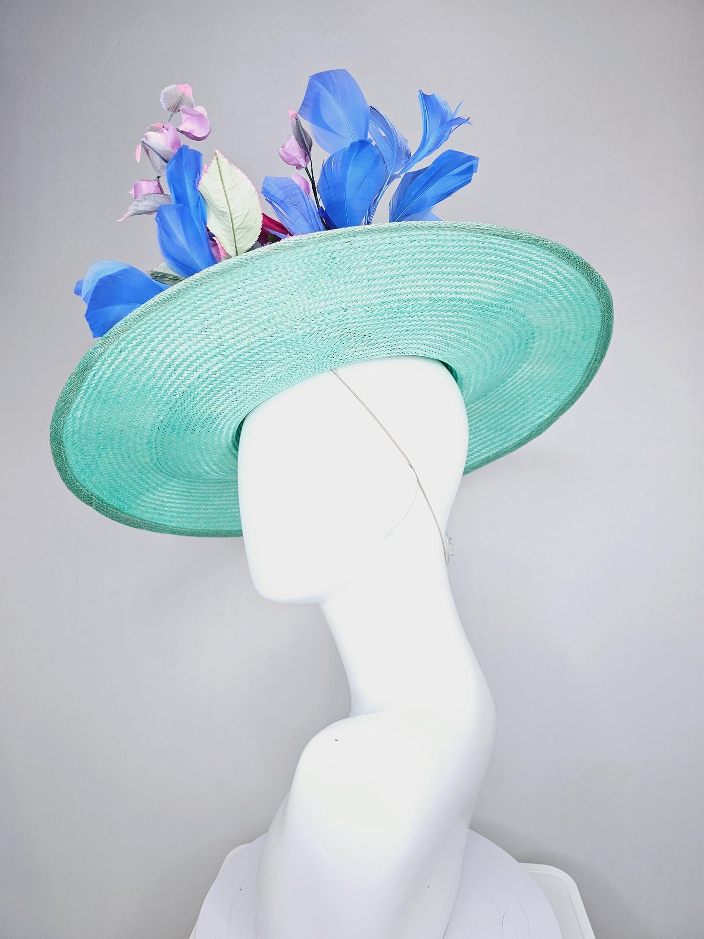kentucky derby hat wide brim straw in aqua mint green with pink satin rose and lilac lavender purple satin rose stems cobalt blue feathers