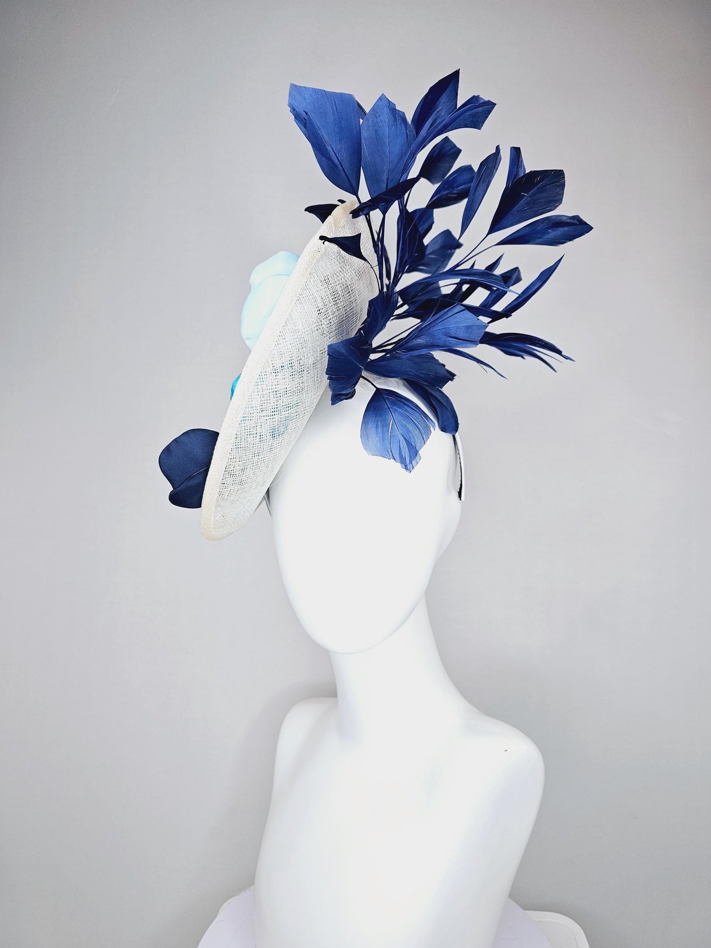 kentucky derby hat fascinator white sinamay saucer with light blue sky blue navy blue satin silk flowers and navy blue branching feathers