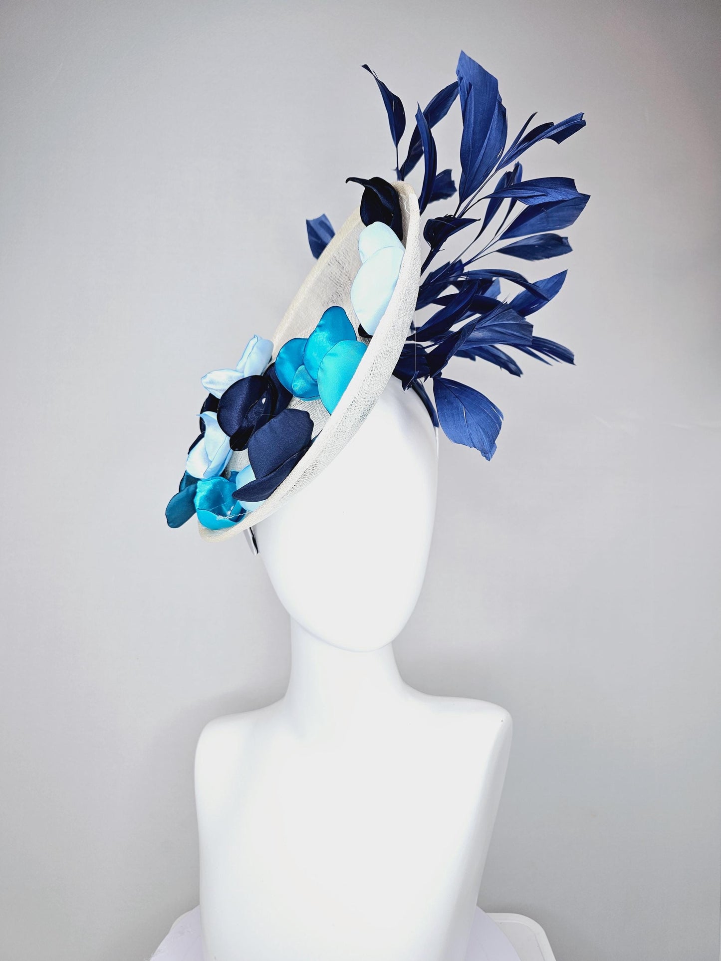 kentucky derby hat fascinator white sinamay saucer with light blue sky blue navy blue satin silk flowers and navy blue branching feathers