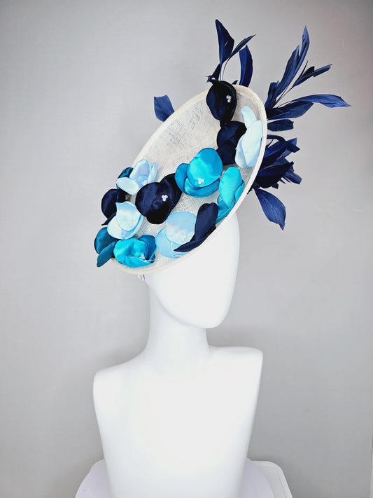 kentucky derby hat fascinator white sinamay saucer with light blue sky blue navy blue satin silk flowers and navy blue branching feathers
