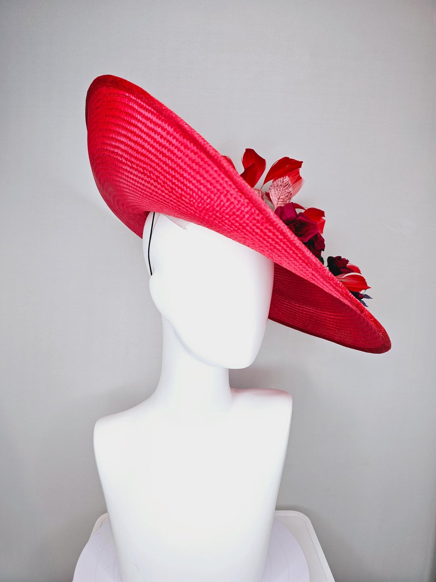 kentucky derby hat wide brim straw in red with scarlet red branching feathers with burgundy red satin roses and light pink dark green leaves