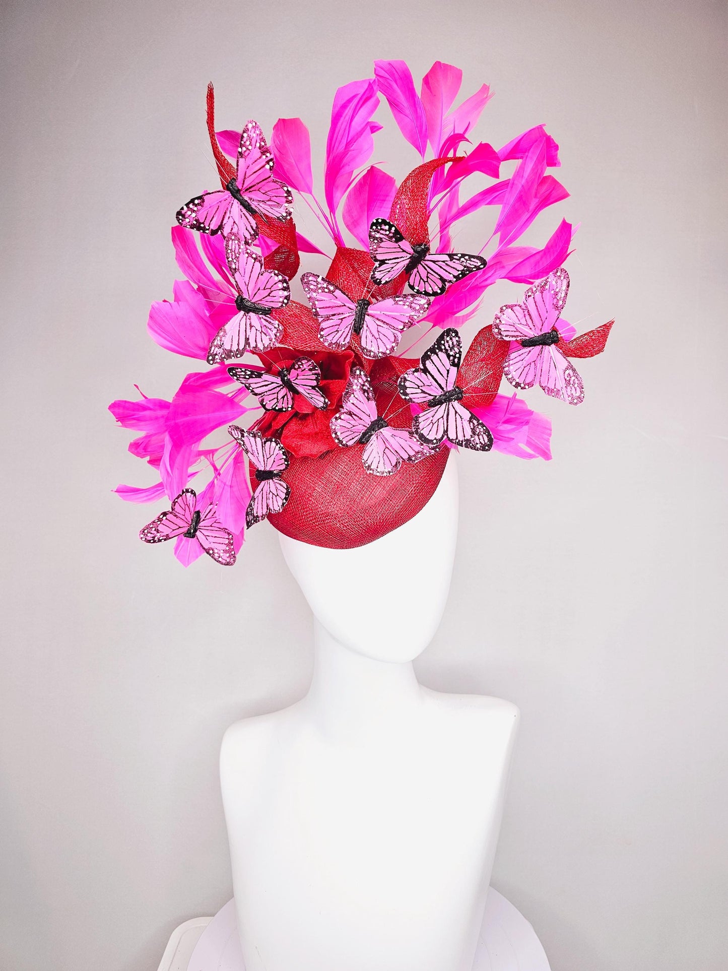 kentucky derby hat fascinator cherry red sinamay with curls hot pink fuchsia branching feathers and pink and black butterflies