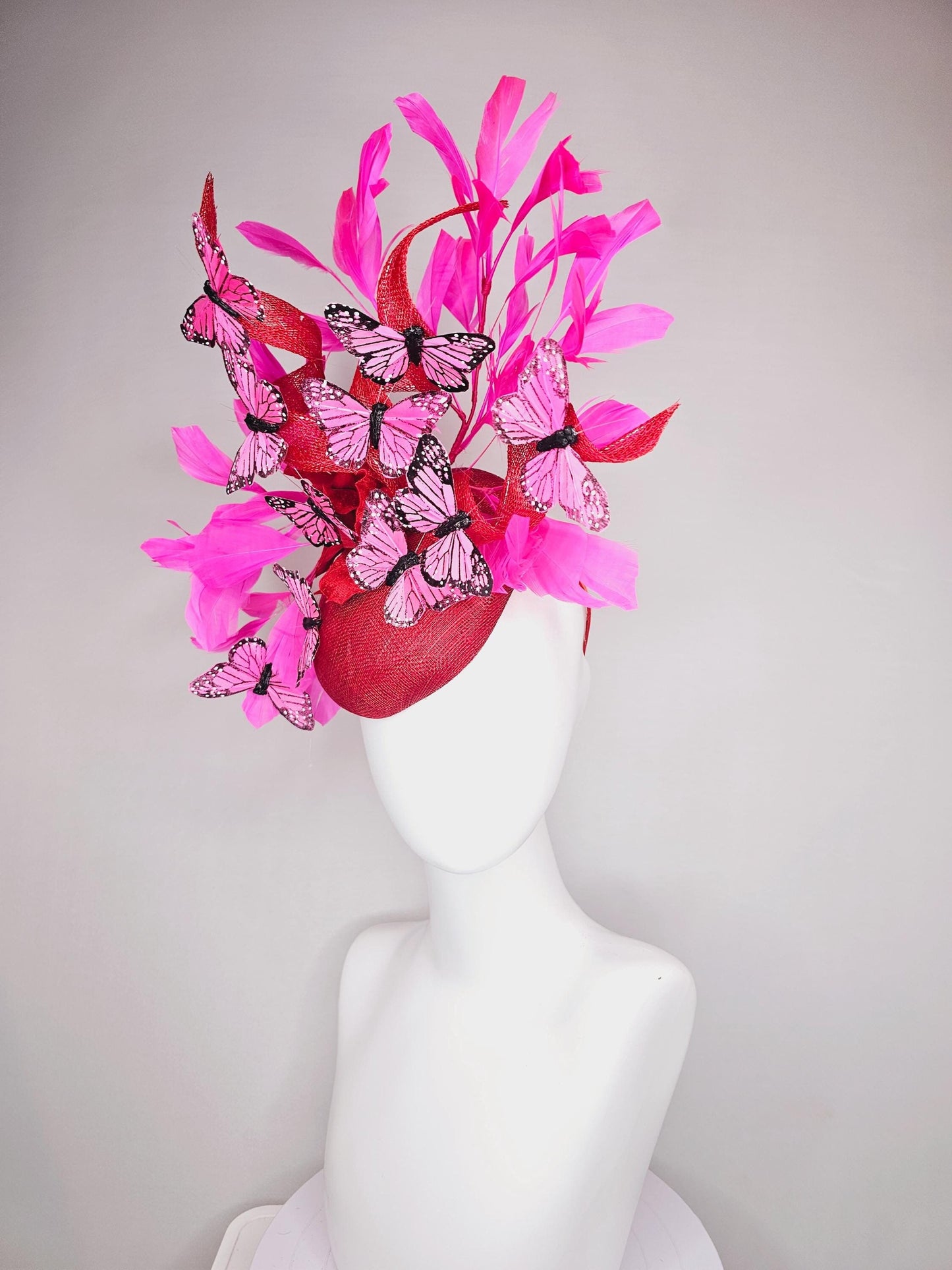 kentucky derby hat fascinator cherry red sinamay with curls hot pink fuchsia branching feathers and pink and black butterflies
