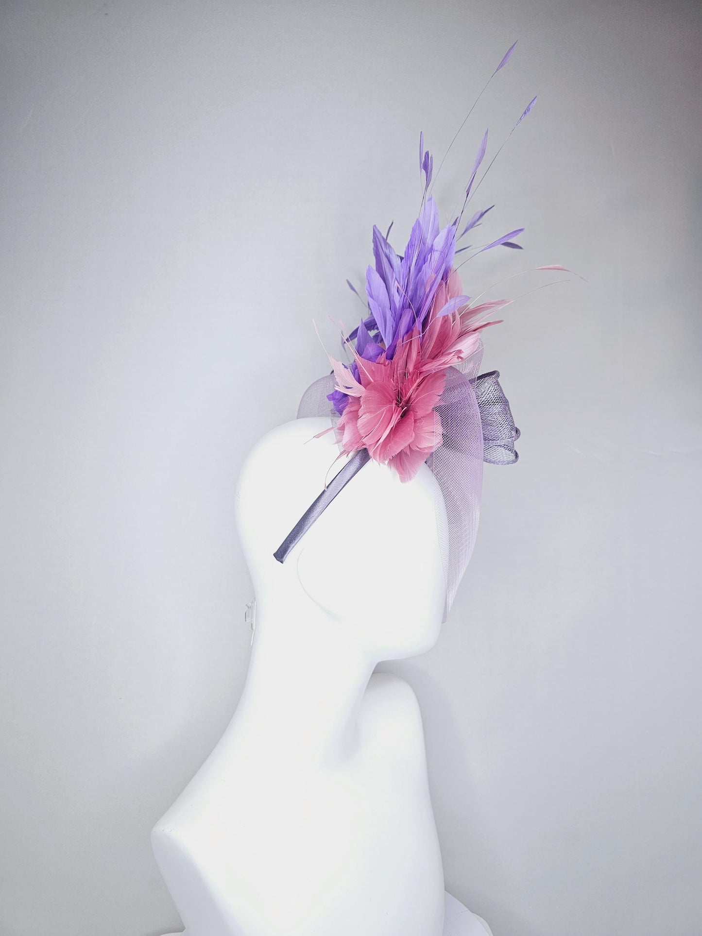 kentucky derby hat fascinator large purple sinamay bow with lavender and light pink branching feathers with purple mesh veil on a headband