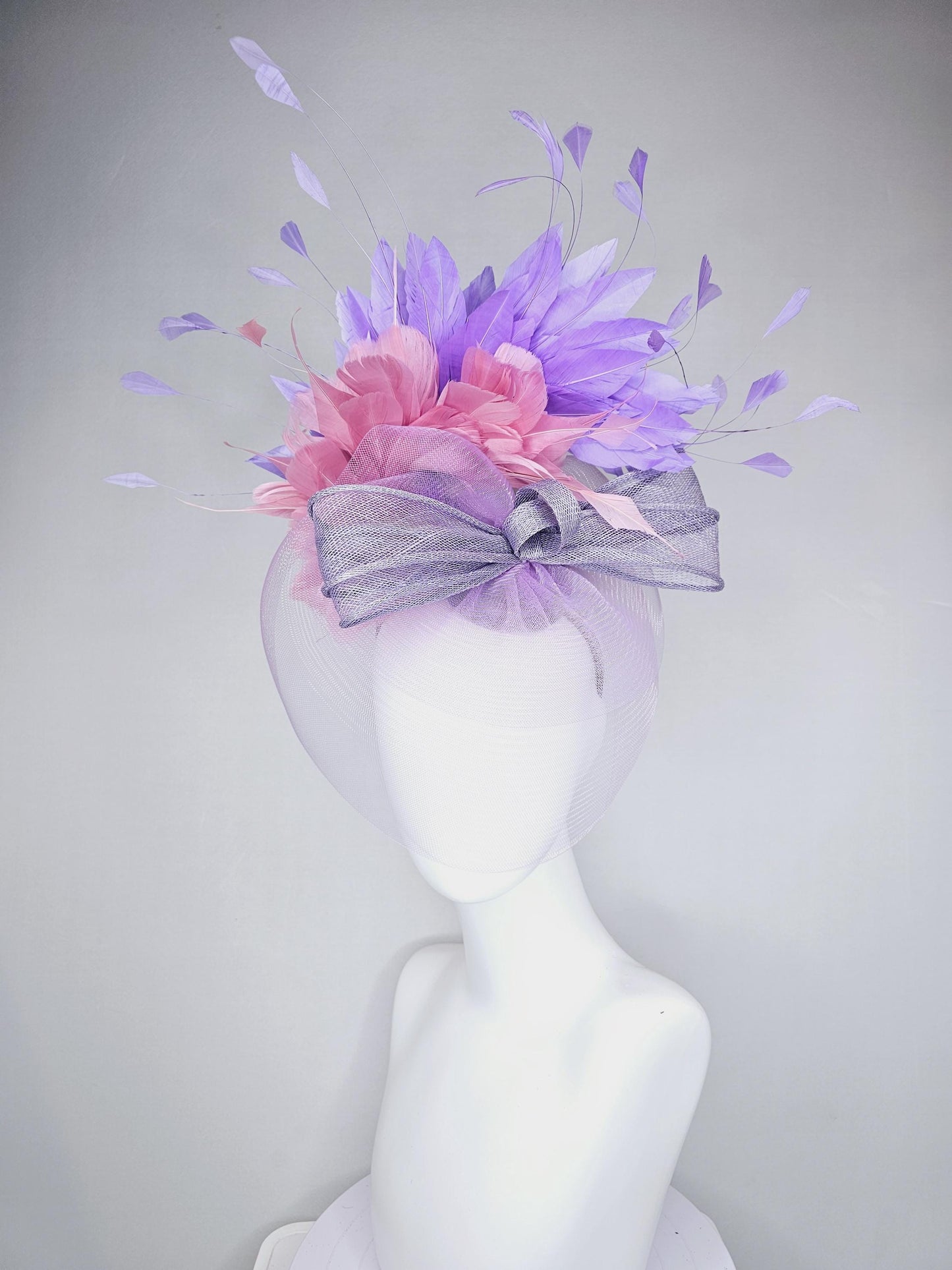 kentucky derby hat fascinator large purple sinamay bow with lavender and light pink branching feathers with purple mesh veil on a headband