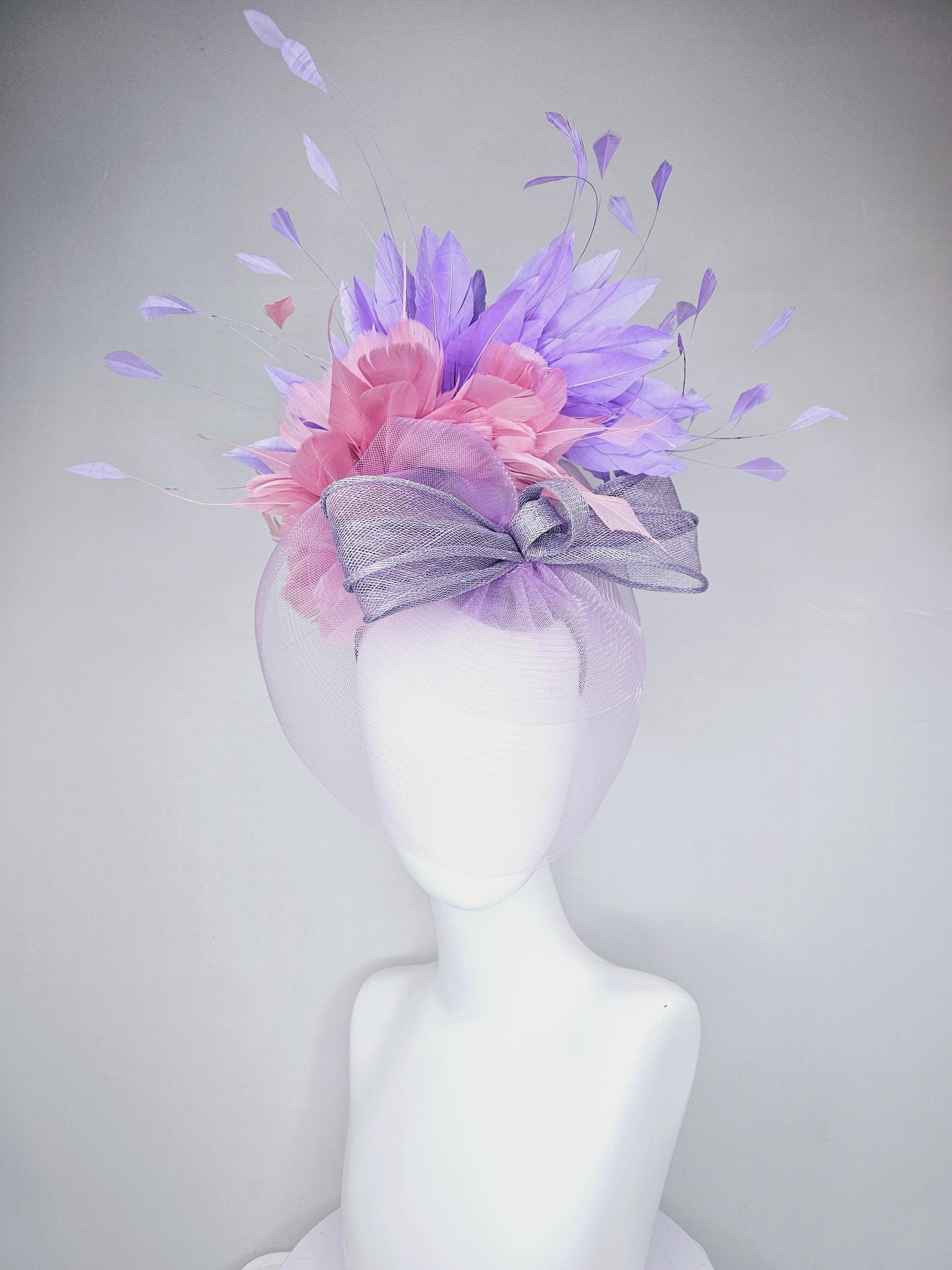 kentucky derby hat fascinator large purple sinamay bow with lavender and light pink branching feathers with purple mesh veil on a headband