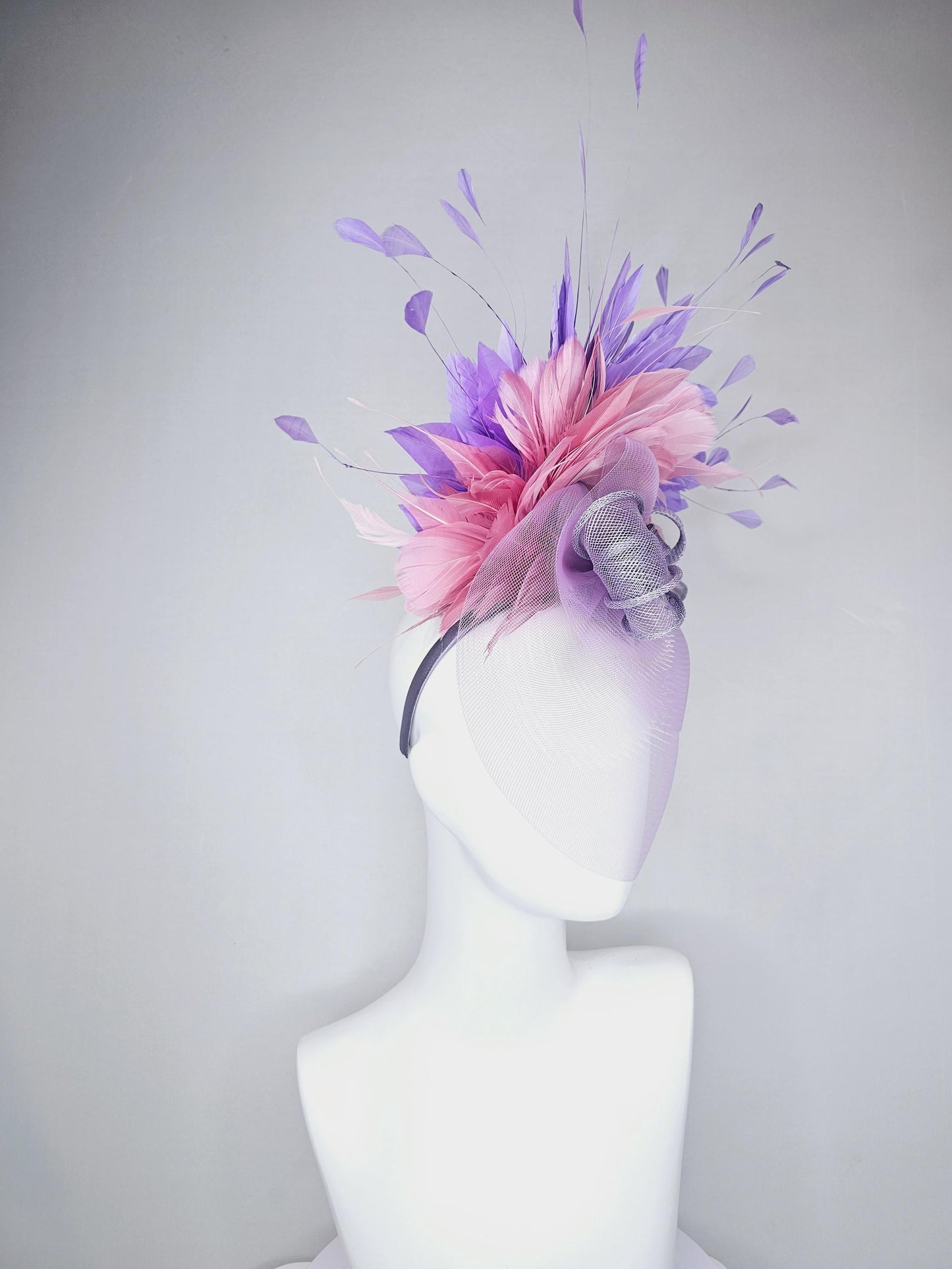 kentucky derby hat fascinator large purple sinamay bow with lavender and light pink branching feathers with purple mesh veil on a headband