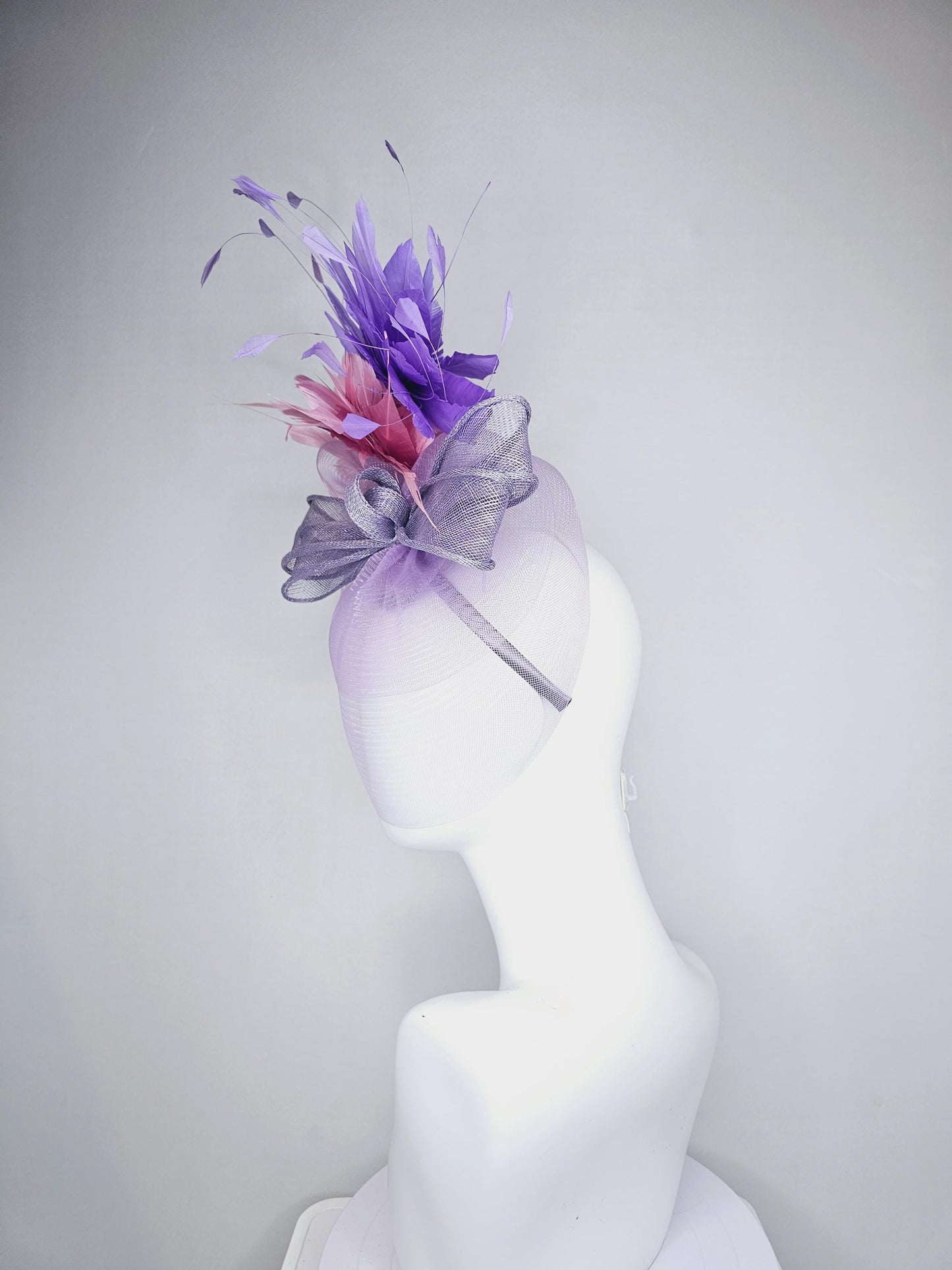 kentucky derby hat fascinator large purple sinamay bow with lavender and light pink branching feathers with purple mesh veil on a headband