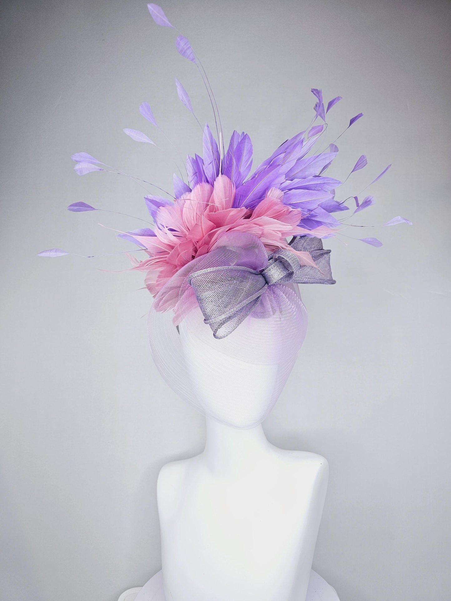 kentucky derby hat fascinator large purple sinamay bow with lavender and light pink branching feathers with purple mesh veil on a headband