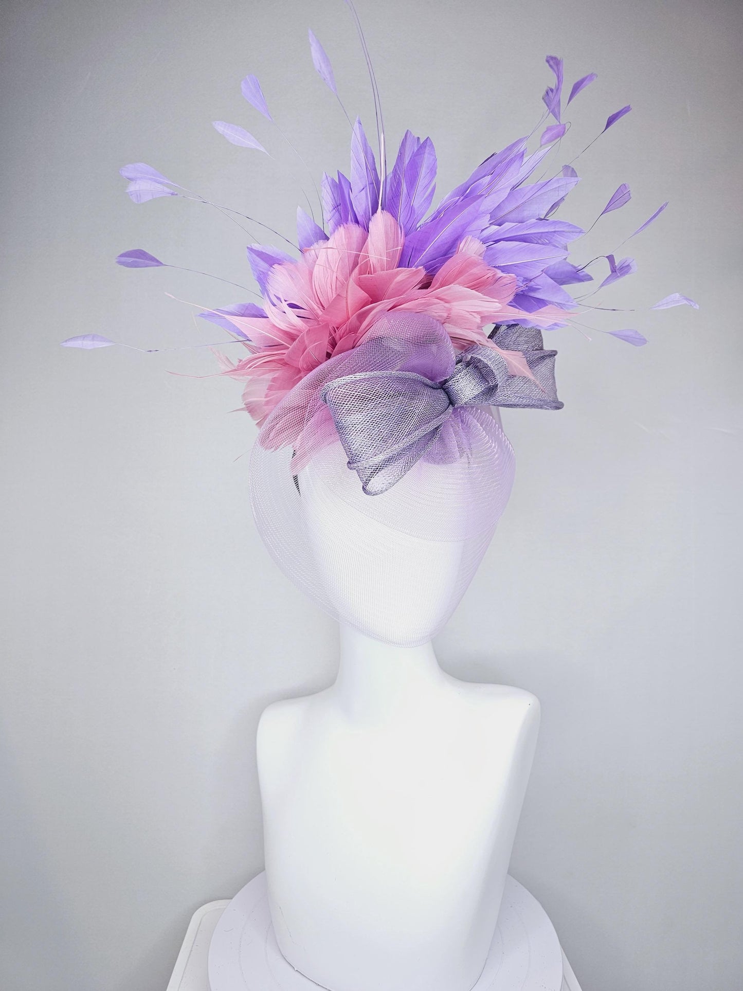 kentucky derby hat fascinator large purple sinamay bow with lavender and light pink branching feathers with purple mesh veil on a headband