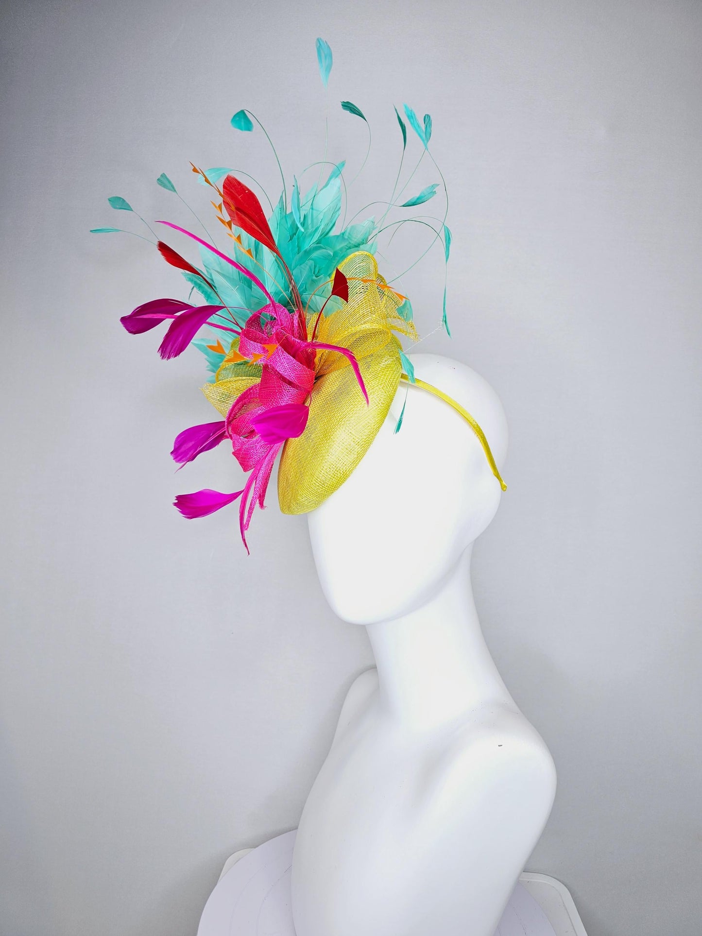 kentucky derby hat fascinator yellow sinamay with yellow and pink sinamay bow pink and red feathers and aqua mint green branching feathers