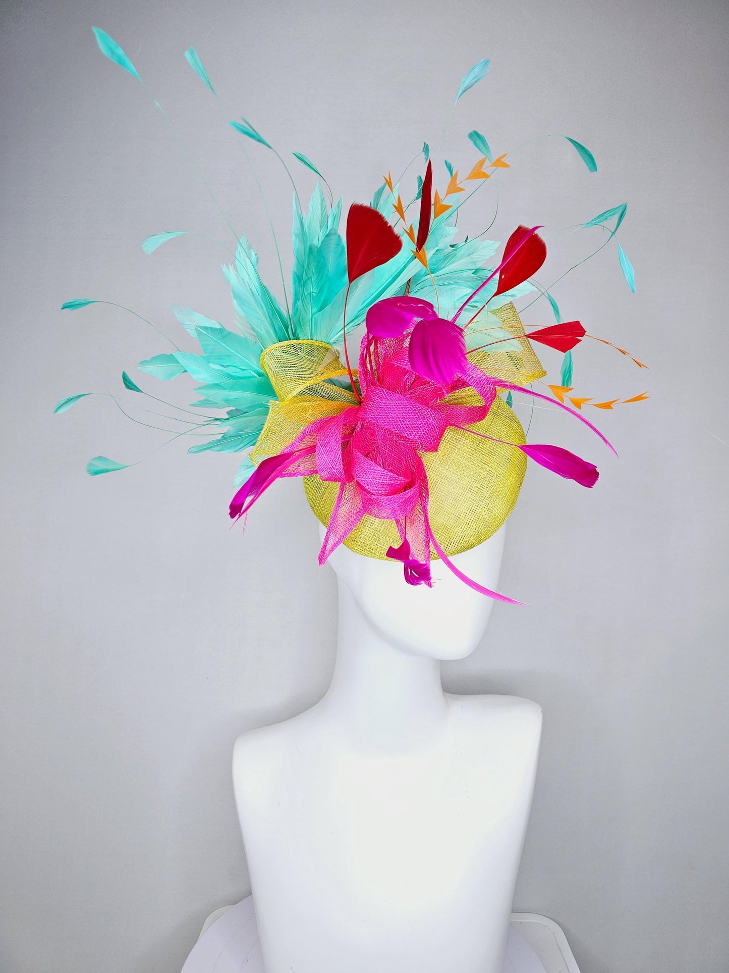 kentucky derby hat fascinator yellow sinamay with yellow and pink sinamay bow pink and red feathers and aqua mint green branching feathers