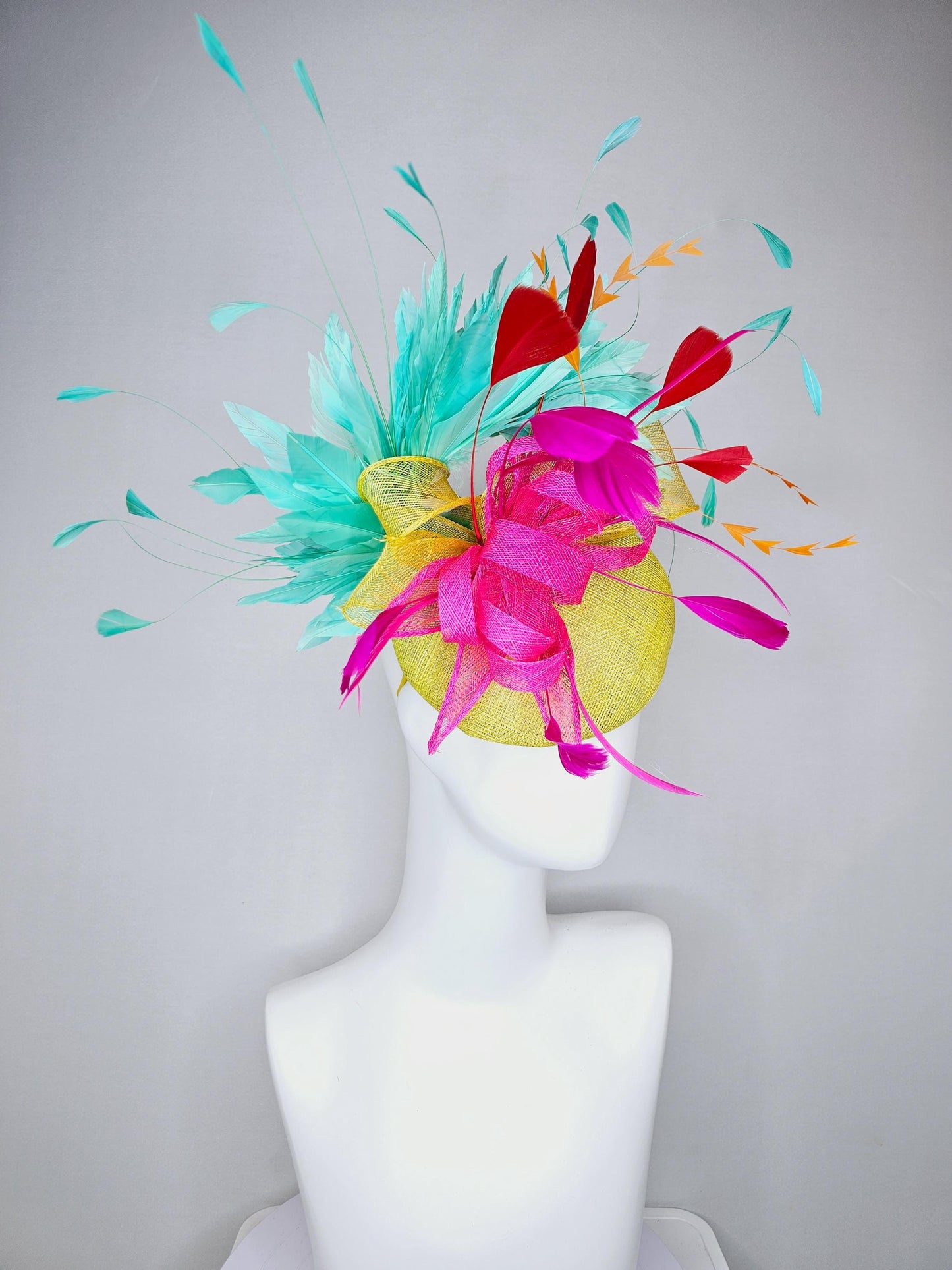 kentucky derby hat fascinator yellow sinamay with yellow and pink sinamay bow pink and red feathers and aqua mint green branching feathers