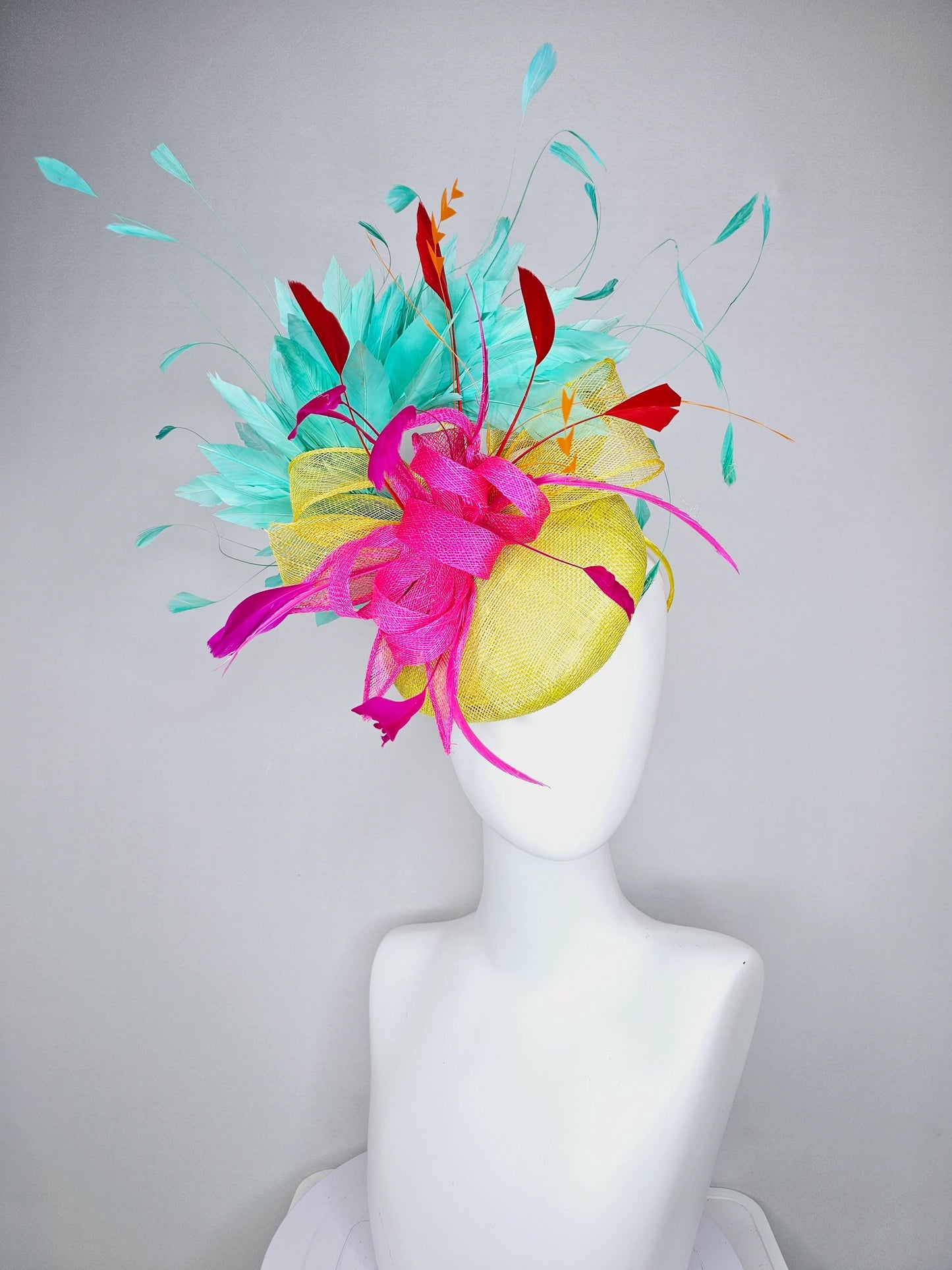 kentucky derby hat fascinator yellow sinamay with yellow and pink sinamay bow pink and red feathers and aqua mint green branching feathers