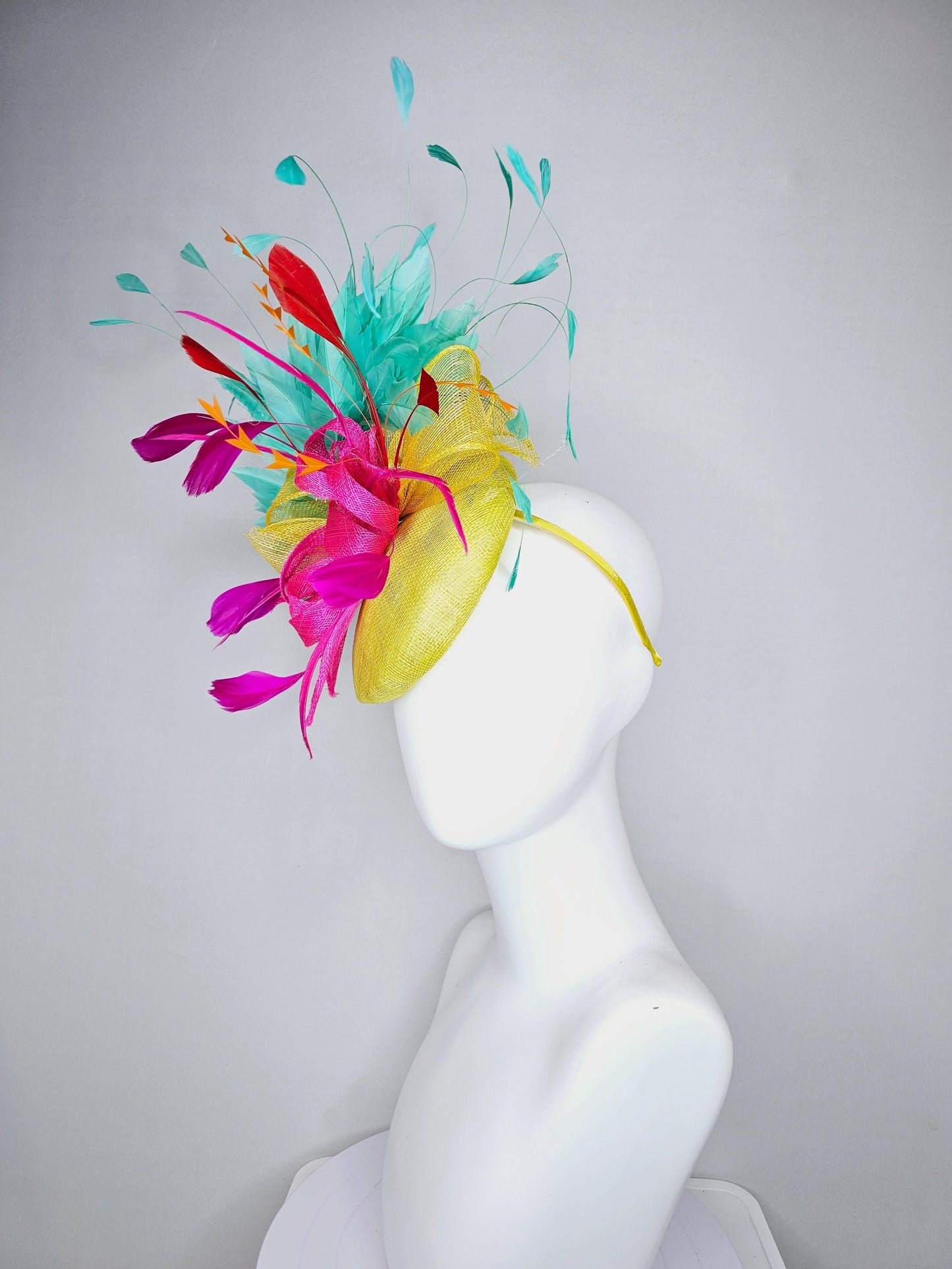 kentucky derby hat fascinator yellow sinamay with yellow and pink sinamay bow pink and red feathers and aqua mint green branching feathers