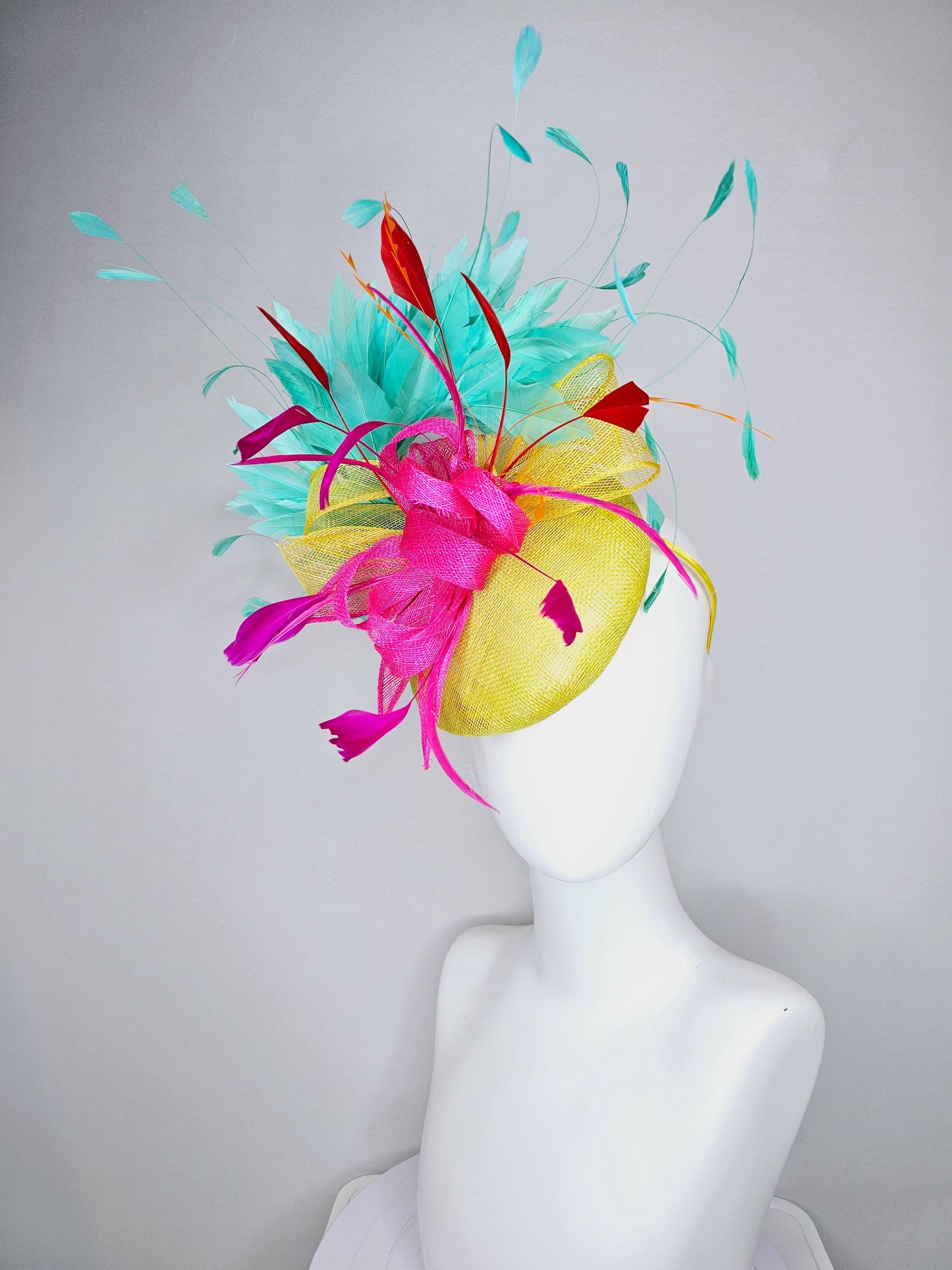 kentucky derby hat fascinator yellow sinamay with yellow and pink sinamay bow pink and red feathers and aqua mint green branching feathers