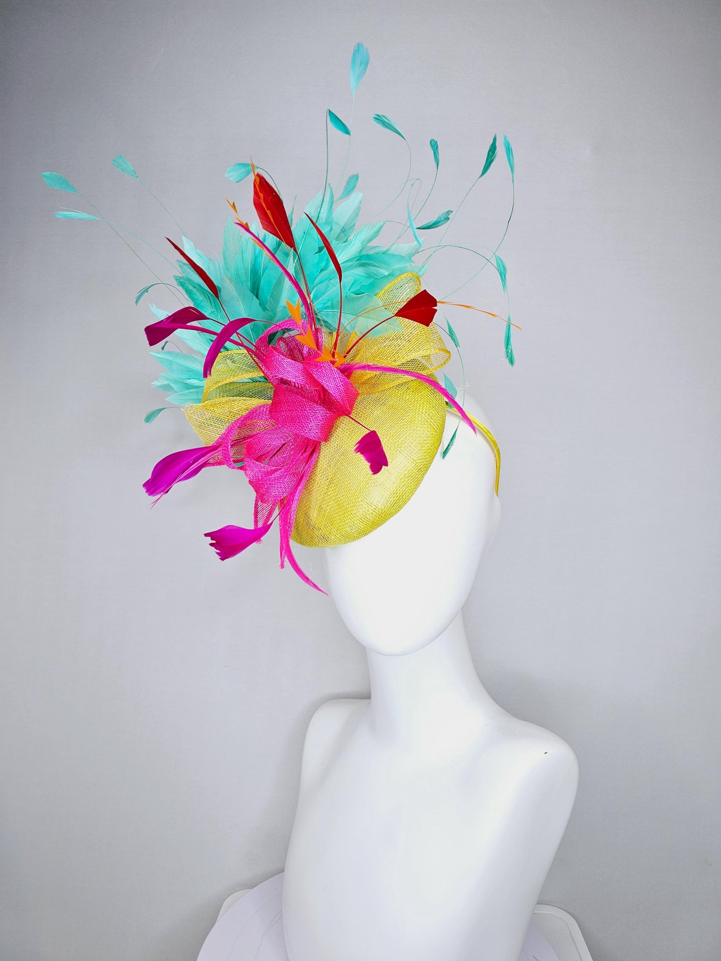kentucky derby hat fascinator yellow sinamay with yellow and pink sinamay bow pink and red feathers and aqua mint green branching feathers