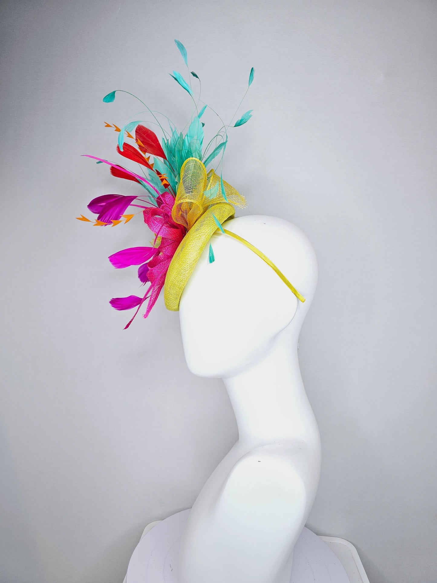 kentucky derby hat fascinator yellow sinamay with yellow and pink sinamay bow pink and red feathers and aqua mint green branching feathers