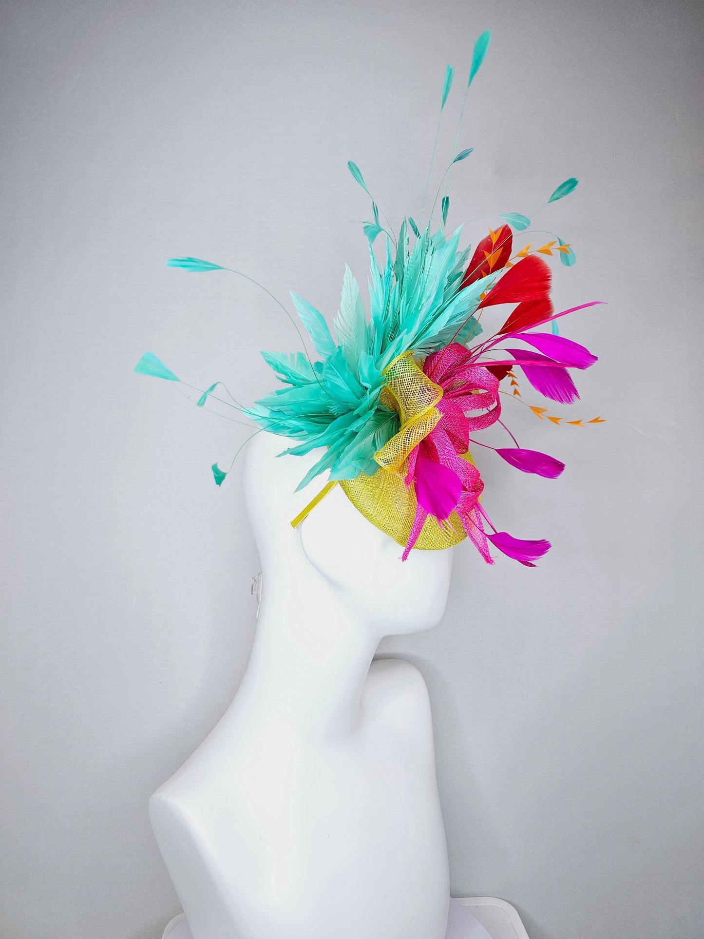 kentucky derby hat fascinator yellow sinamay with yellow and pink sinamay bow pink and red feathers and aqua mint green branching feathers