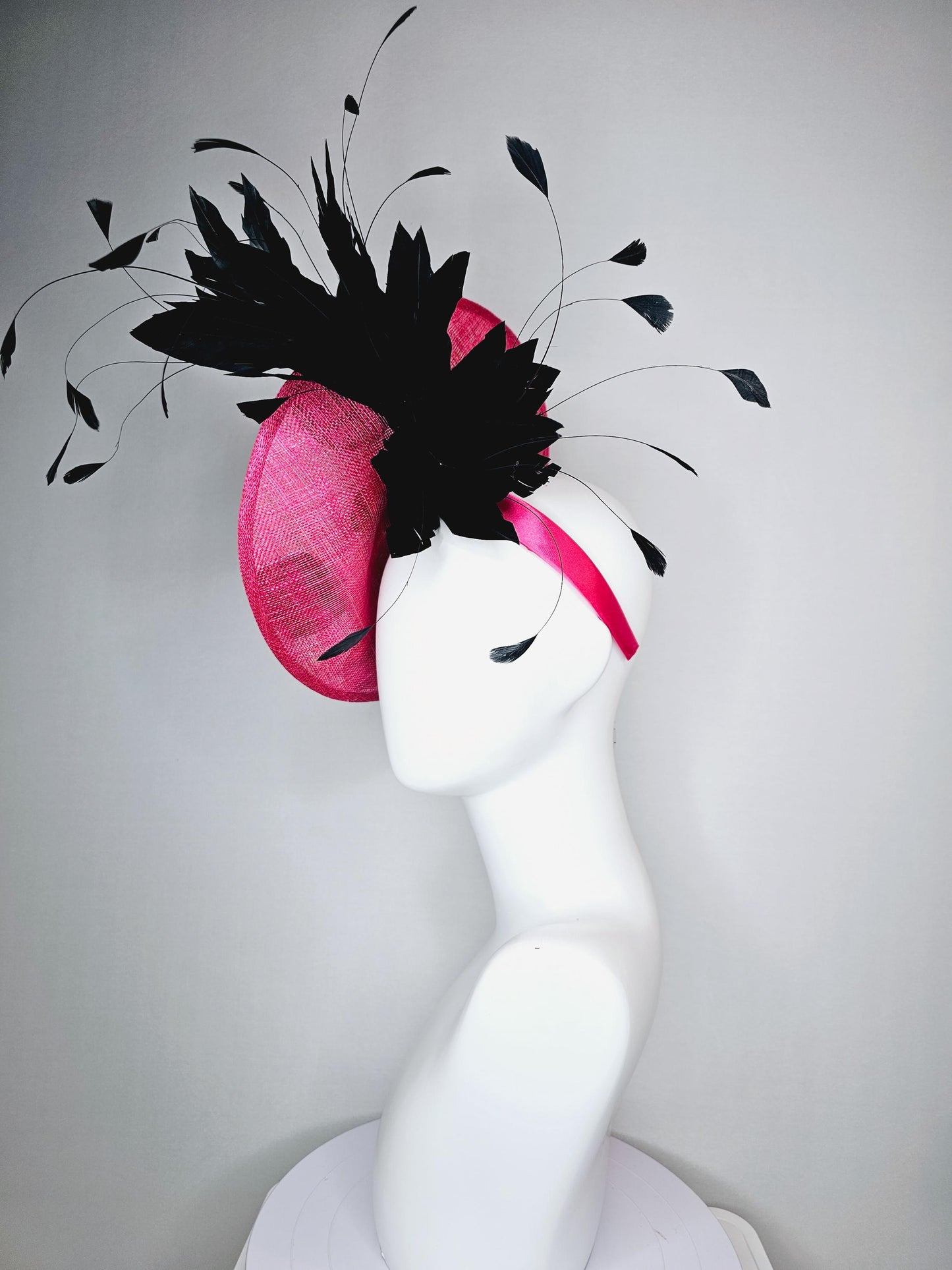 kentucky derby hat fascinator raspberry pink sinamay saucer with black and white satin flowers and black branch feathers