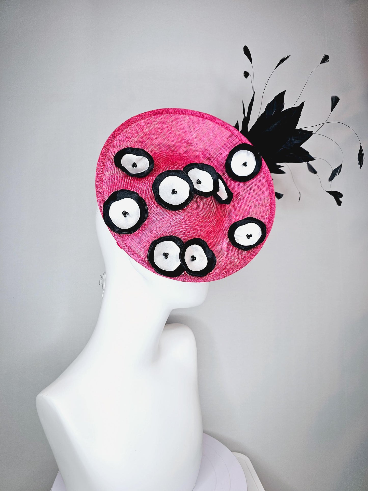kentucky derby hat fascinator raspberry pink sinamay saucer with black and white satin flowers and black branch feathers