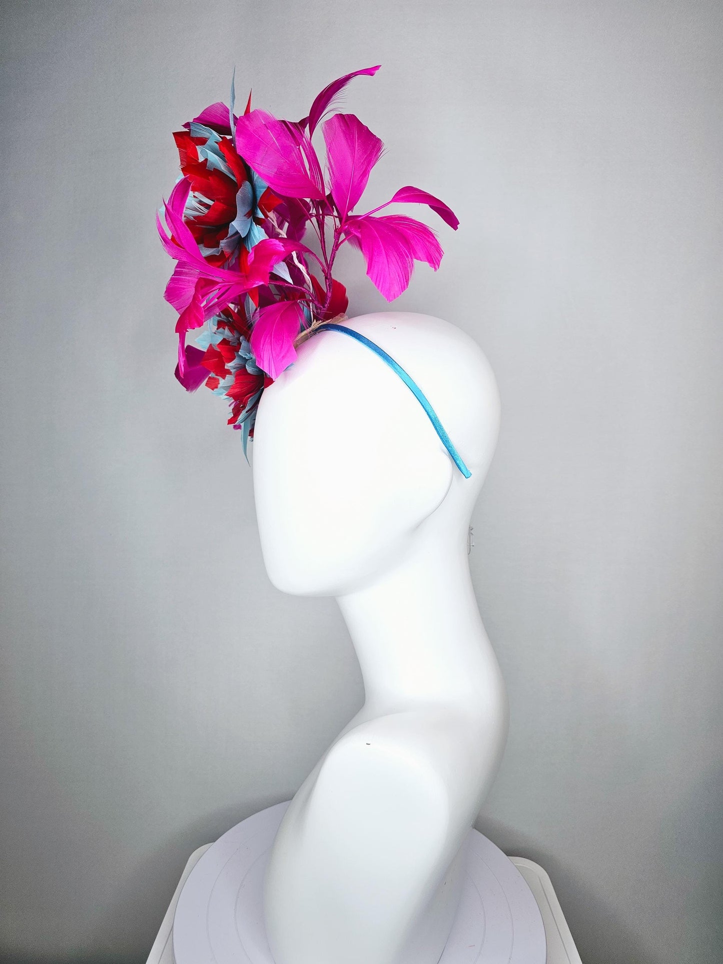 kentucky derby hat fascinator with large scarlet red and baby blue feather flowers and bright pink branching feathers
