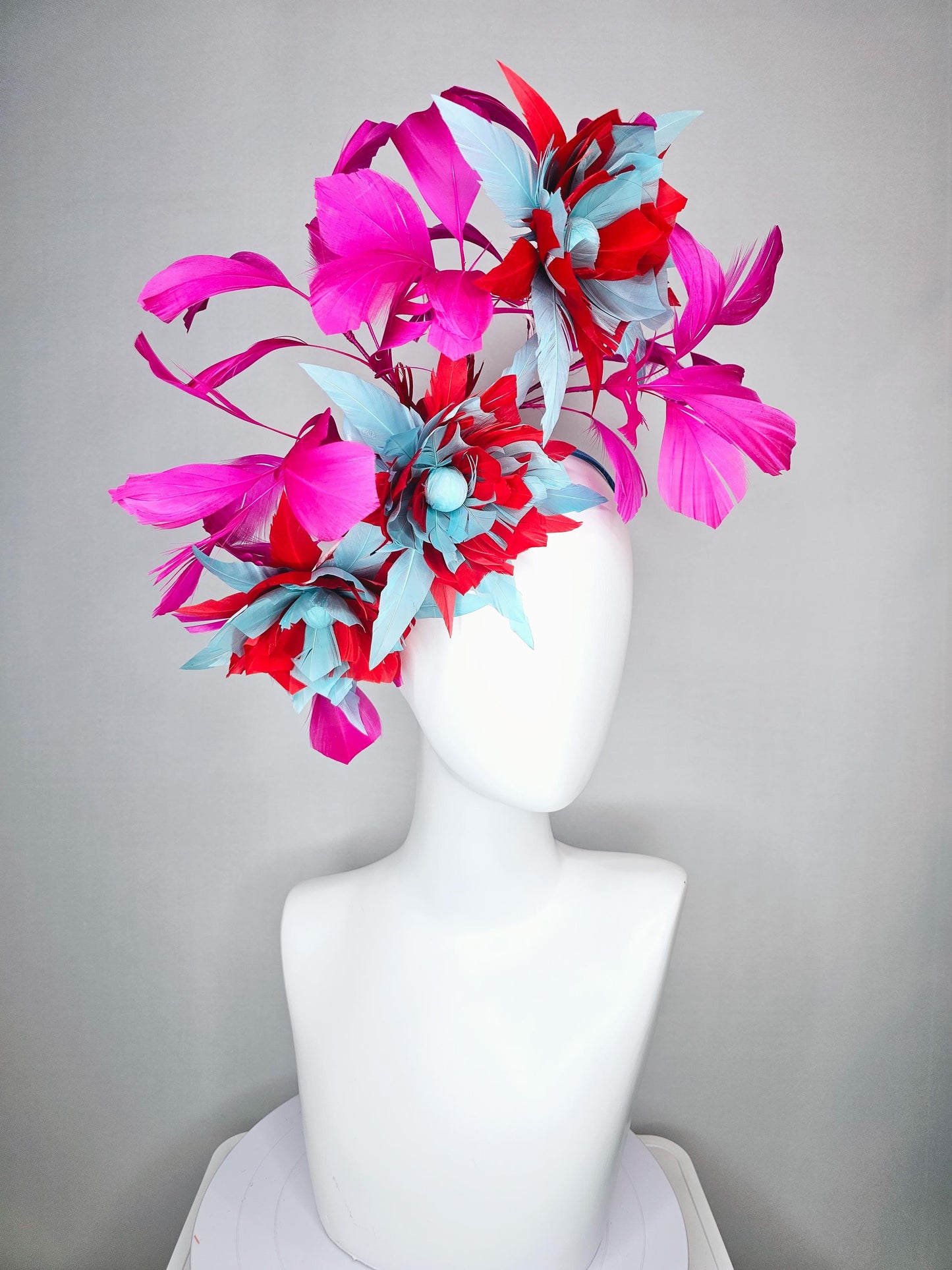 kentucky derby hat fascinator with large scarlet red and baby blue feather flowers and bright pink branching feathers