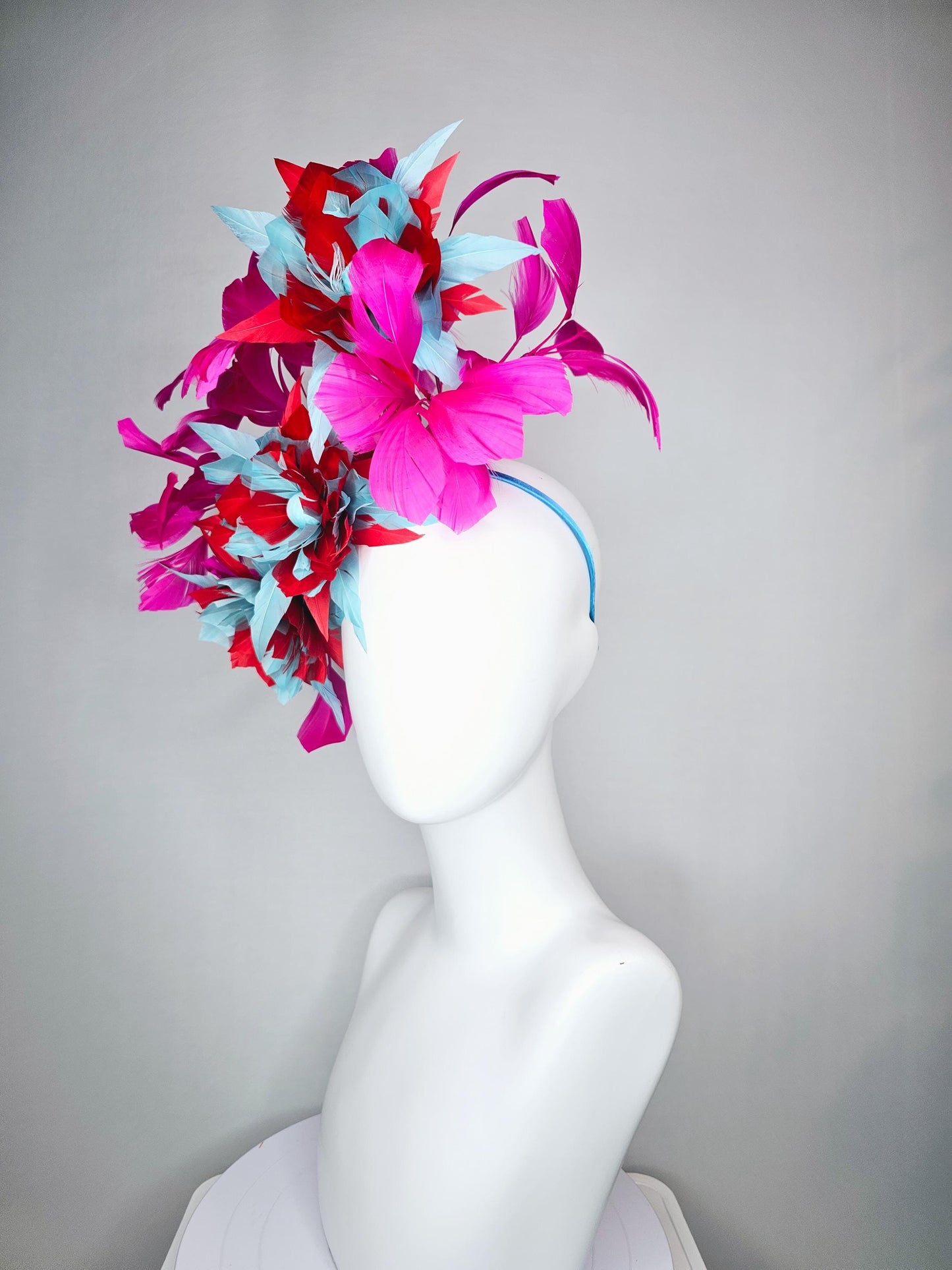 kentucky derby hat fascinator with large scarlet red and baby blue feather flowers and bright pink branching feathers