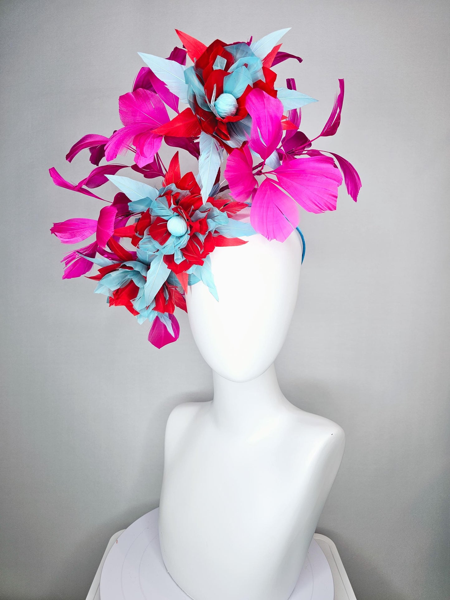 kentucky derby hat fascinator with large scarlet red and baby blue feather flowers and bright pink branching feathers